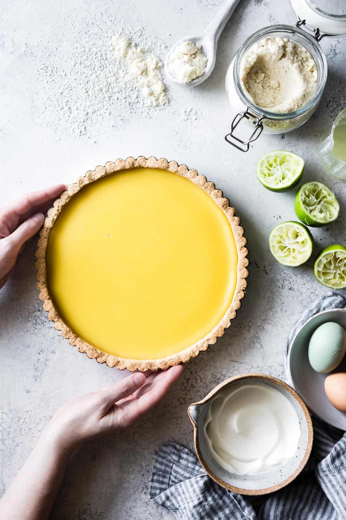 hands holding Gluten Free Lime Curd Tart