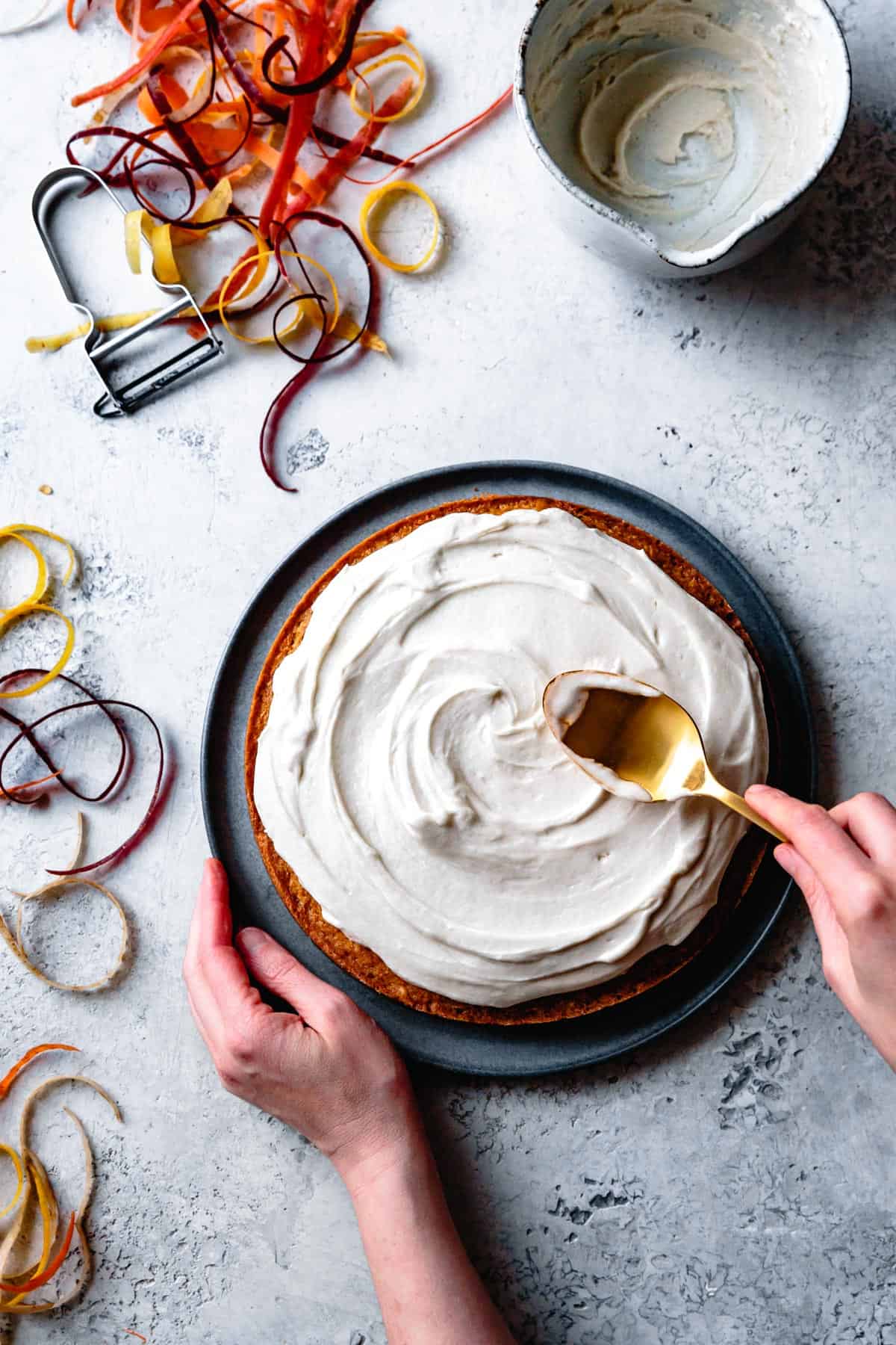 spreading Vegan Cream Cheese Frosting on cake 