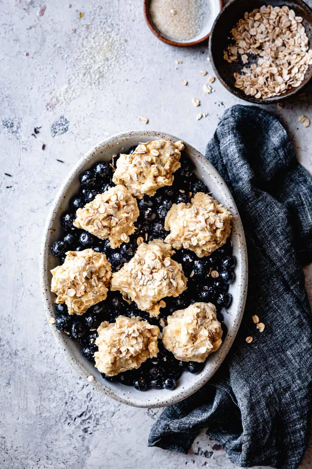 Gluten-Free dairy-free blueberry cobbler with oatmeal topping before baking