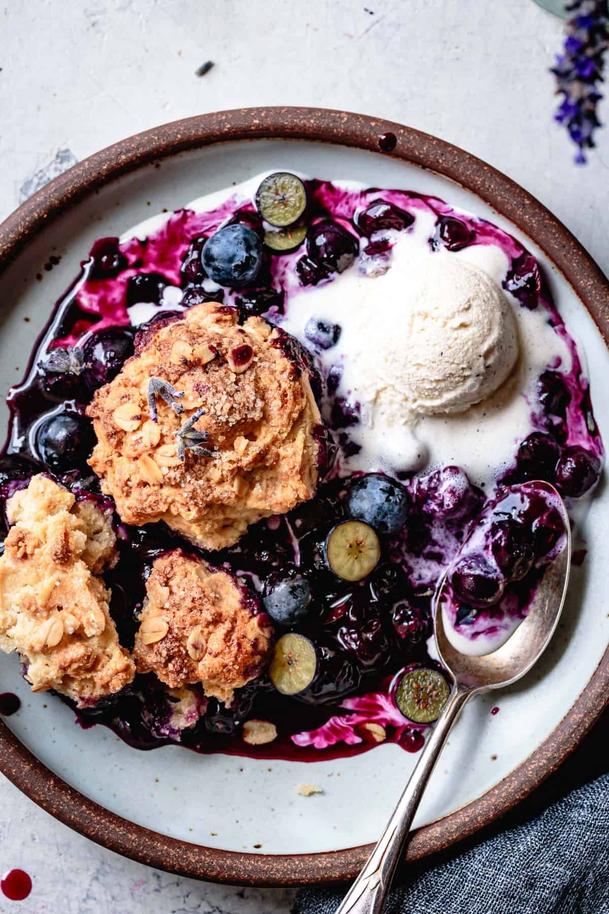gluten-free blueberry cobbler recipe, on a plate with ice cream
