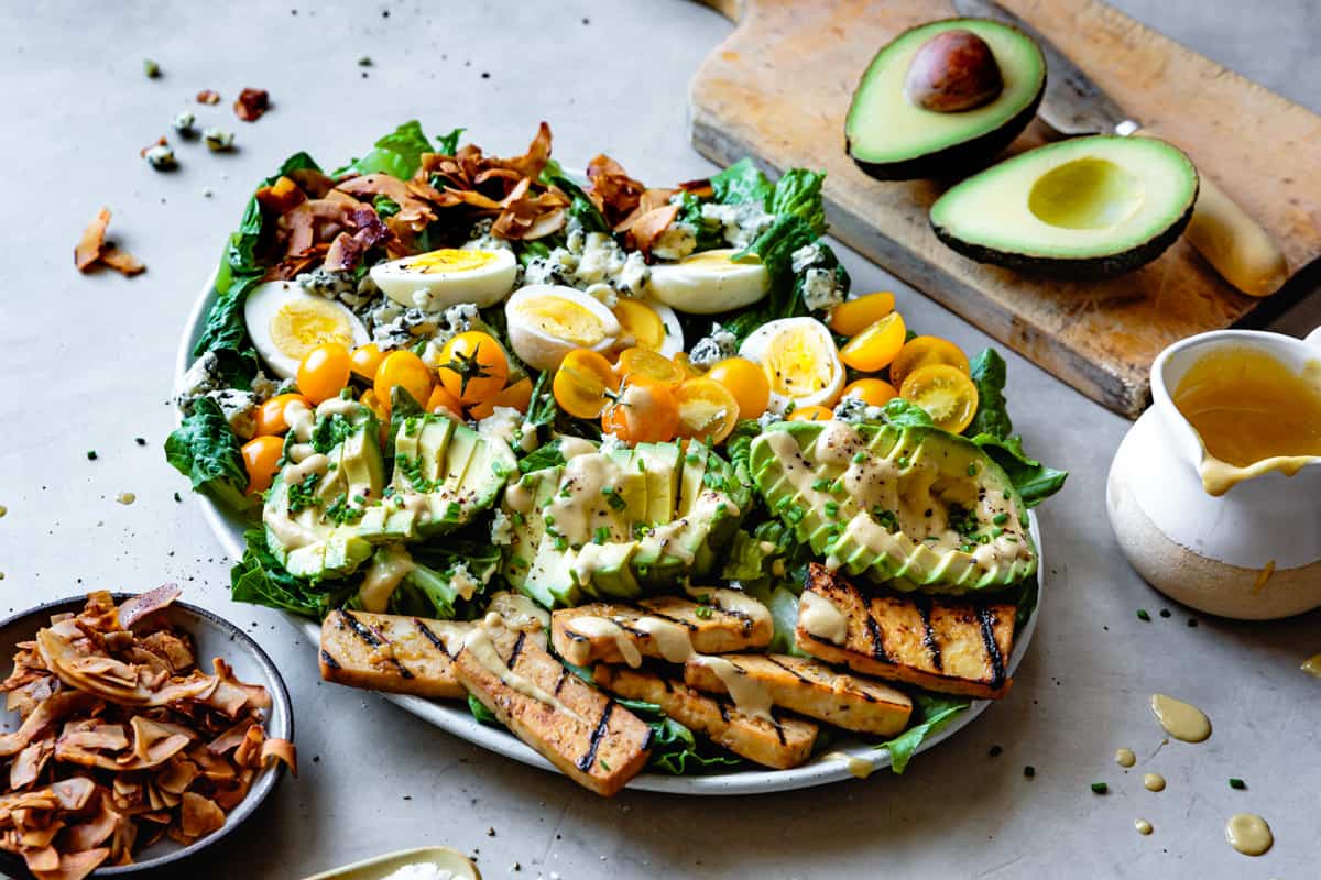 Vegetarian Cobb Salad with Grilled Tofu & Coconut Bacon on big plate 