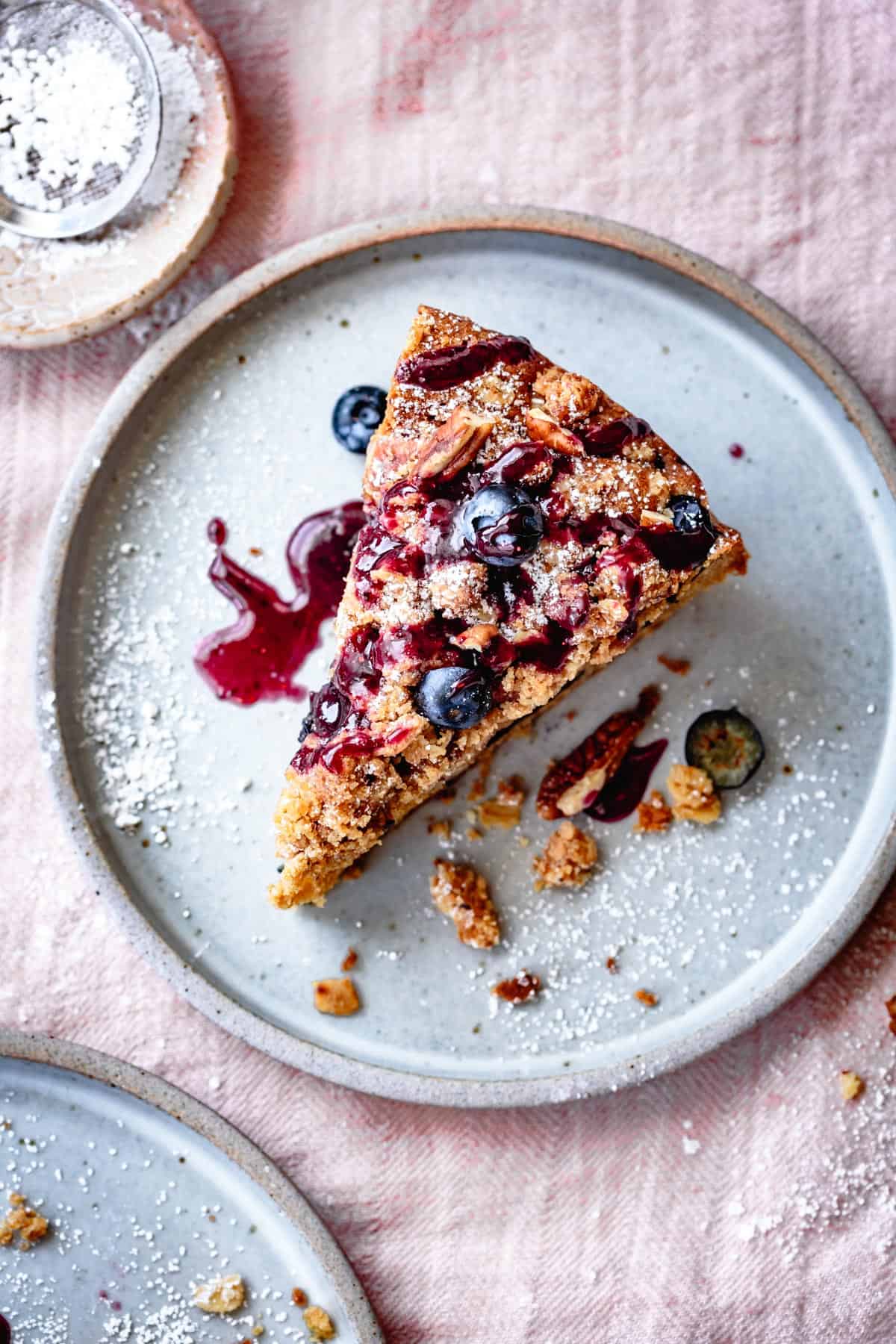 top down shot of Gluten Free Blueberry Coffee Cake slice on a plate