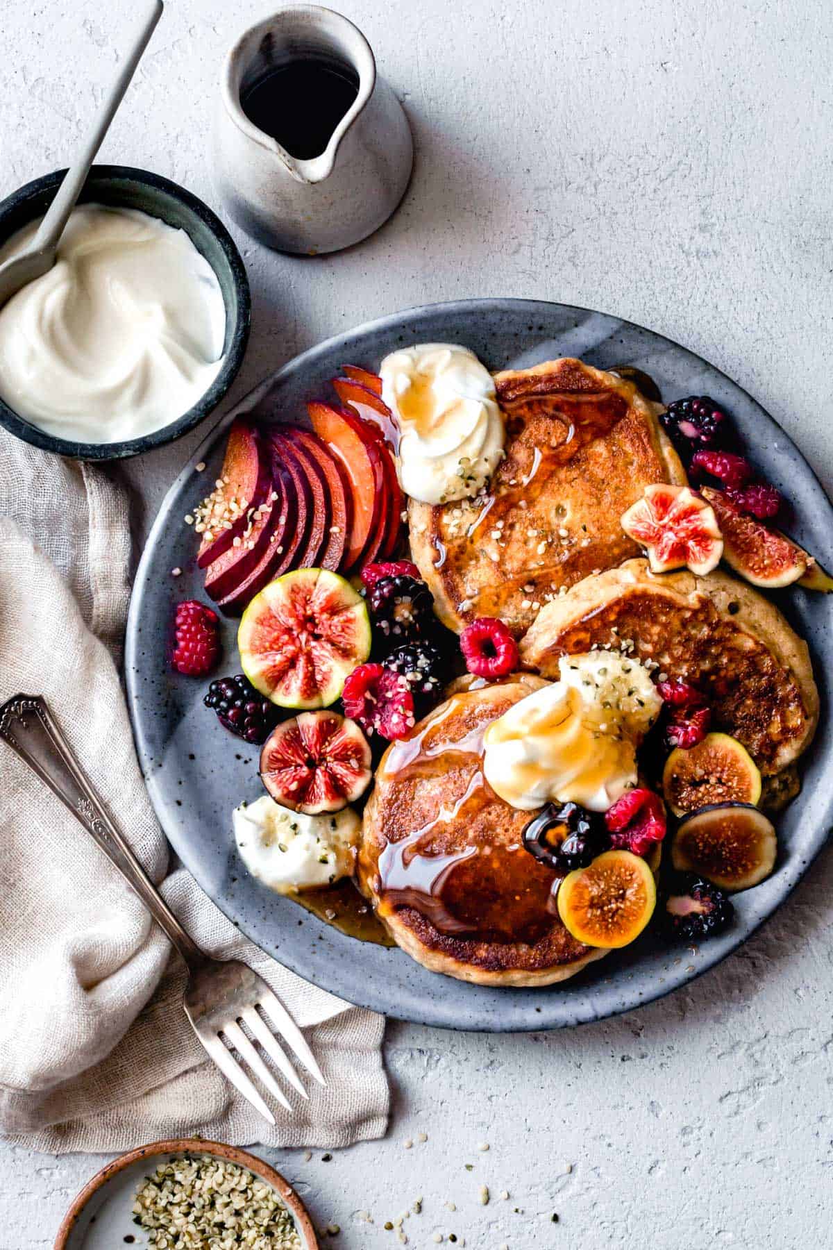 Fluffy Gluten-Free Pancakes with yogurt, maple syrup, and hemp seed