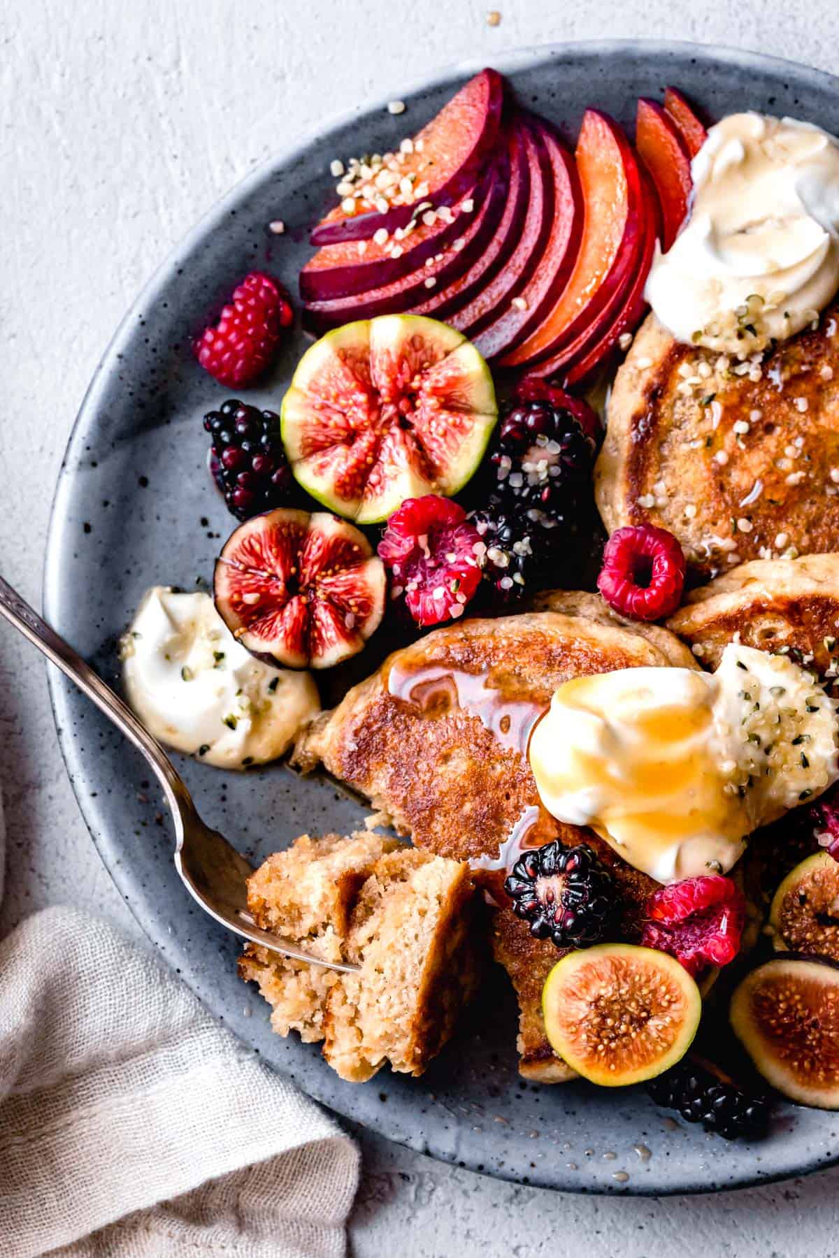 Gluten Free sorghum flour Pancakes are shown close-up with seasonal fruit