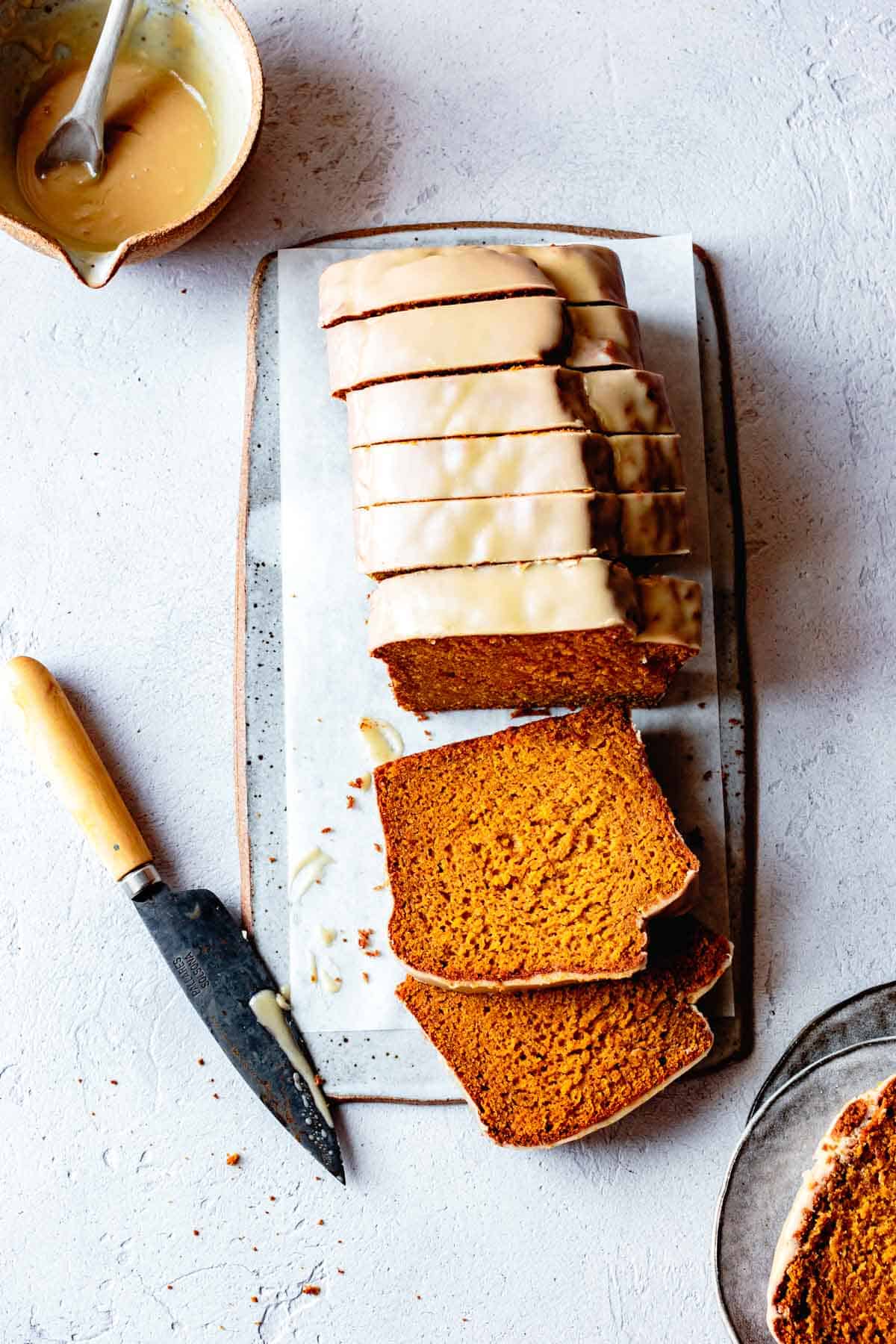 Gluten-free pumpkin loaf recipe, sliced on a board overhead