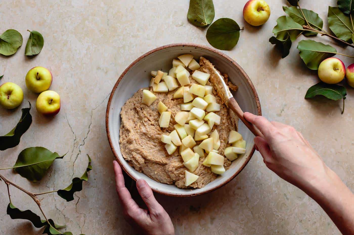 Adding apples to batter for gluten-free apple cake recipe