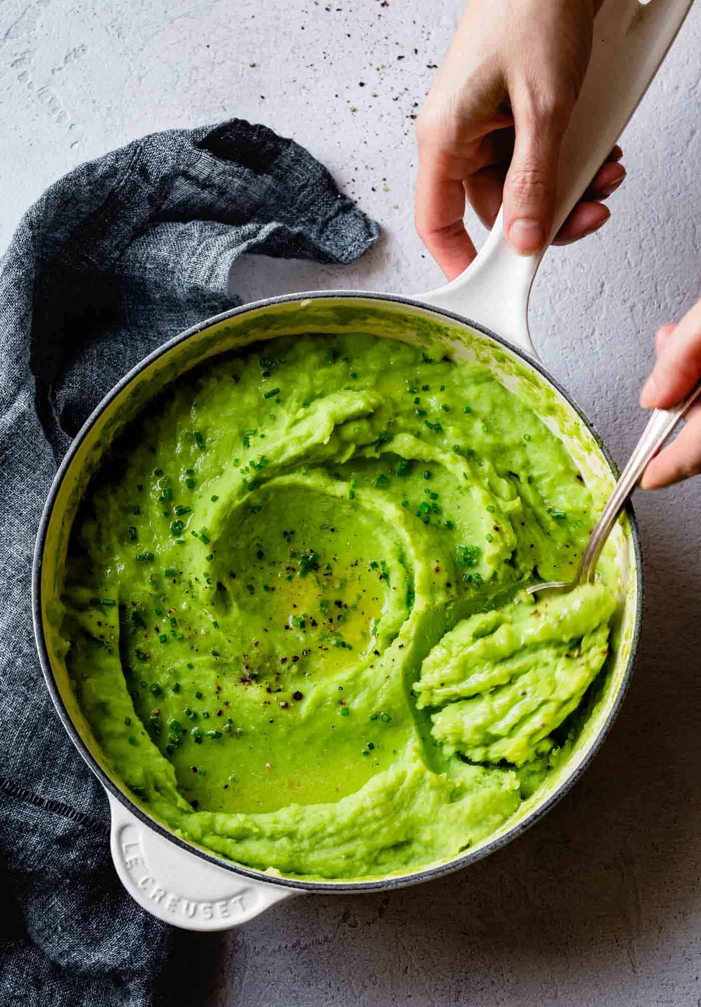 Spooning Green Mashed Potatoes from a pot