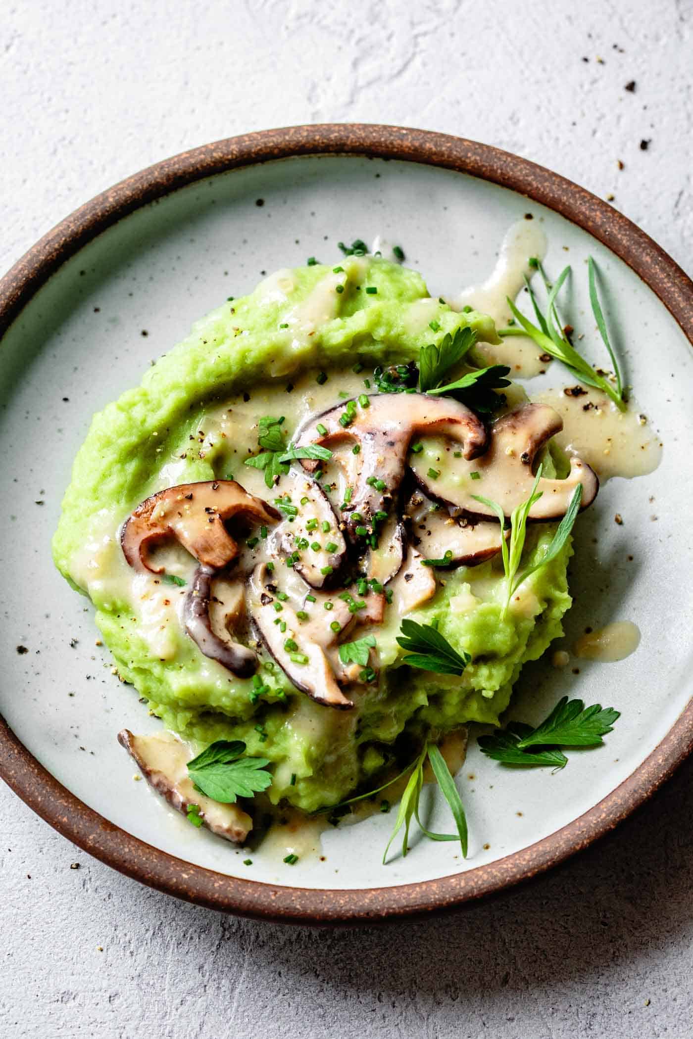 Green mashed potatoes and mushroom gravy on a plate