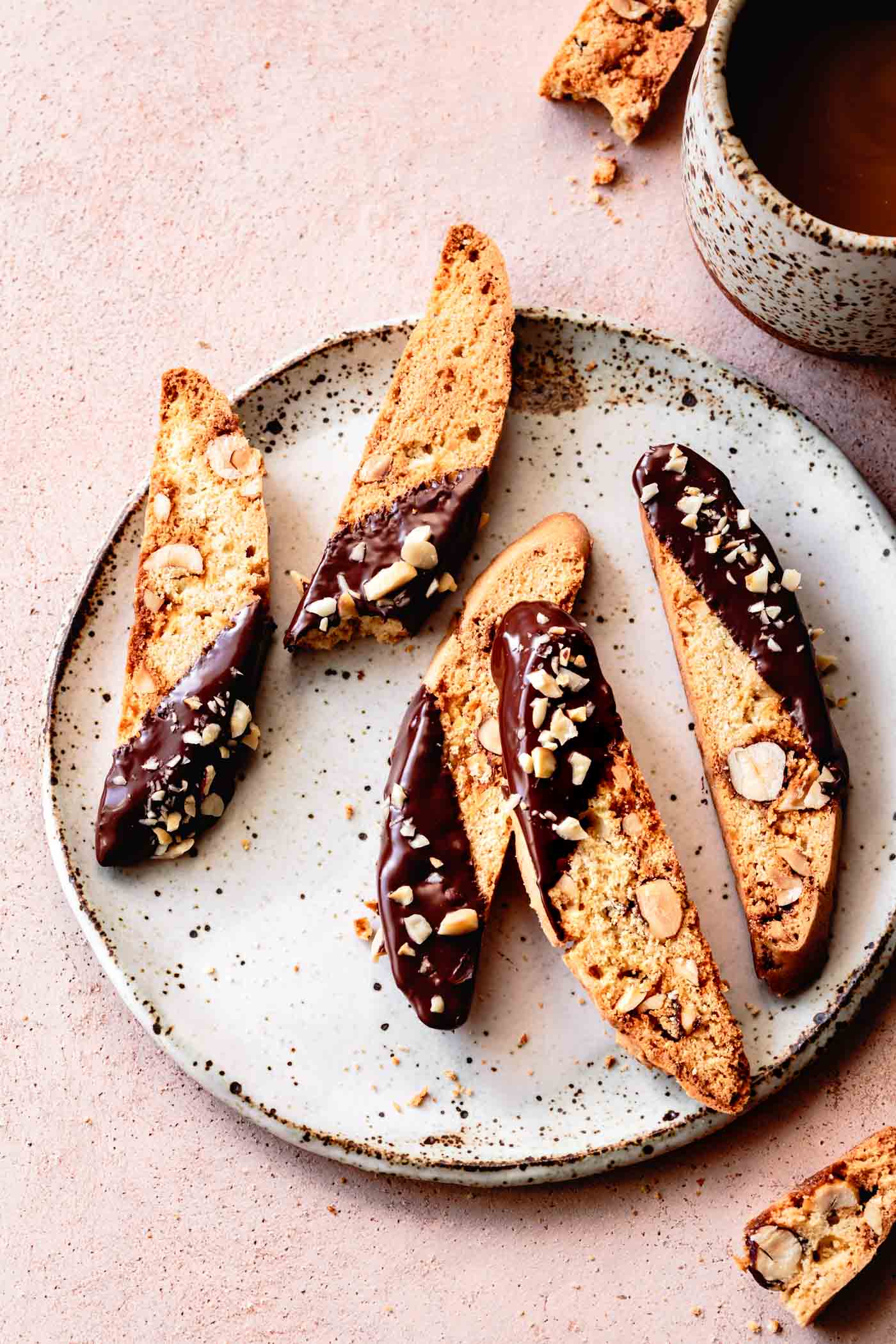 A plate of Gluten-Free Biscotti with Hazelnuts & Chocolate served with coffee