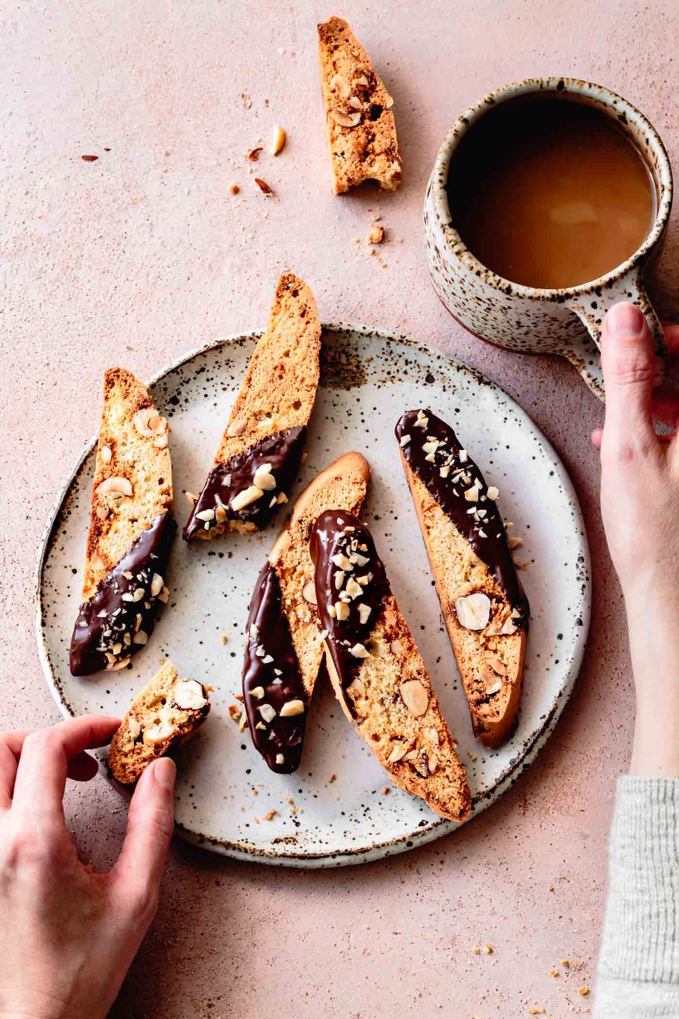 Gluten-Free Biscotti with Hazelnuts & Chocolate being eaten with coffee