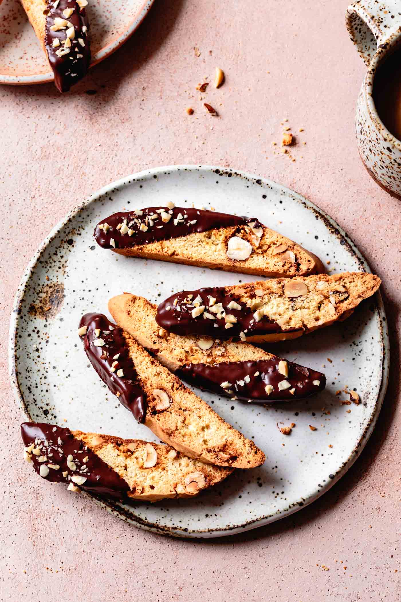 Gluten-Free Biscotti with Hazelnuts & Chocolate on a plate with coffee