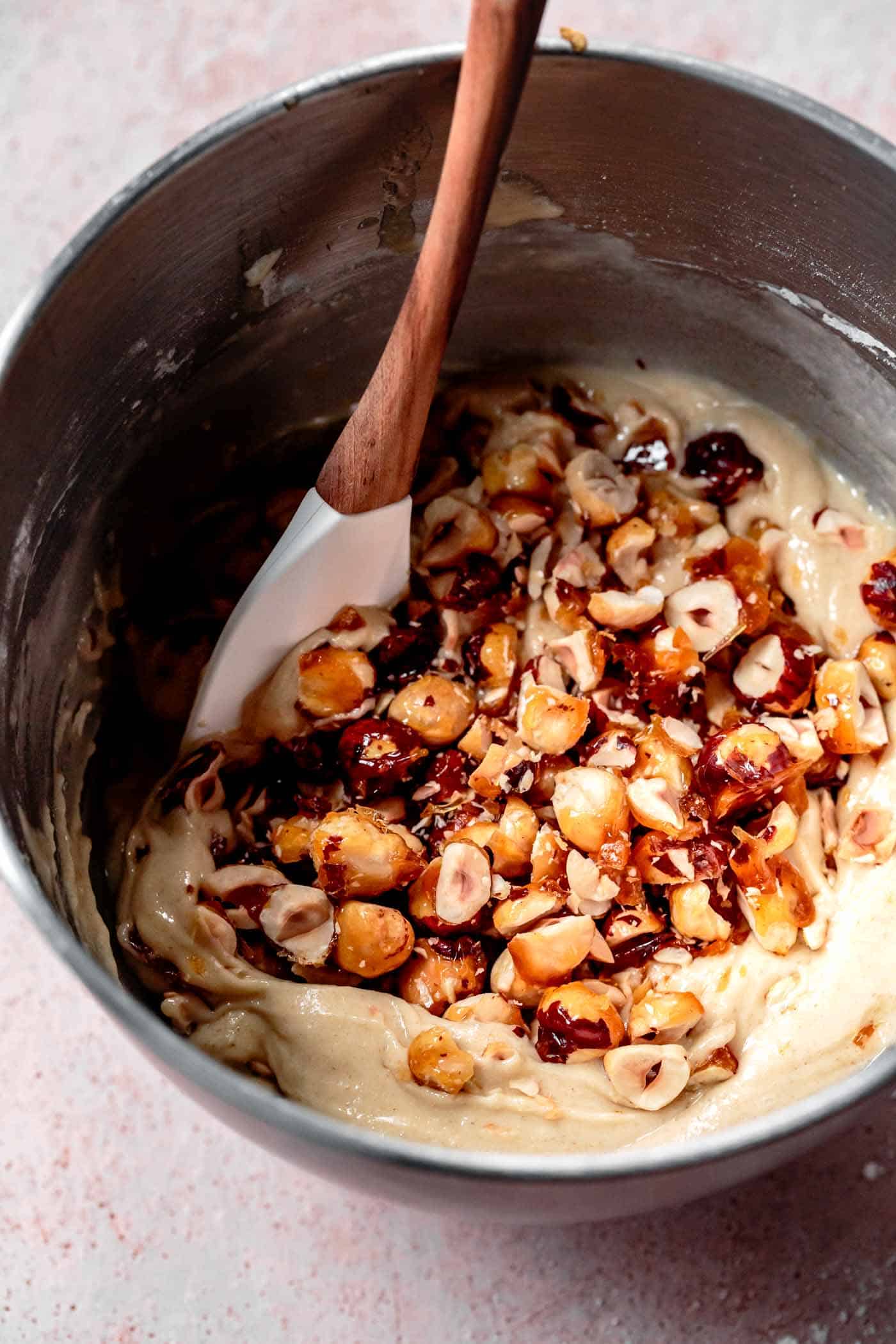 Stirring candied hazelnuts into gluten-free biscotti cookie dough