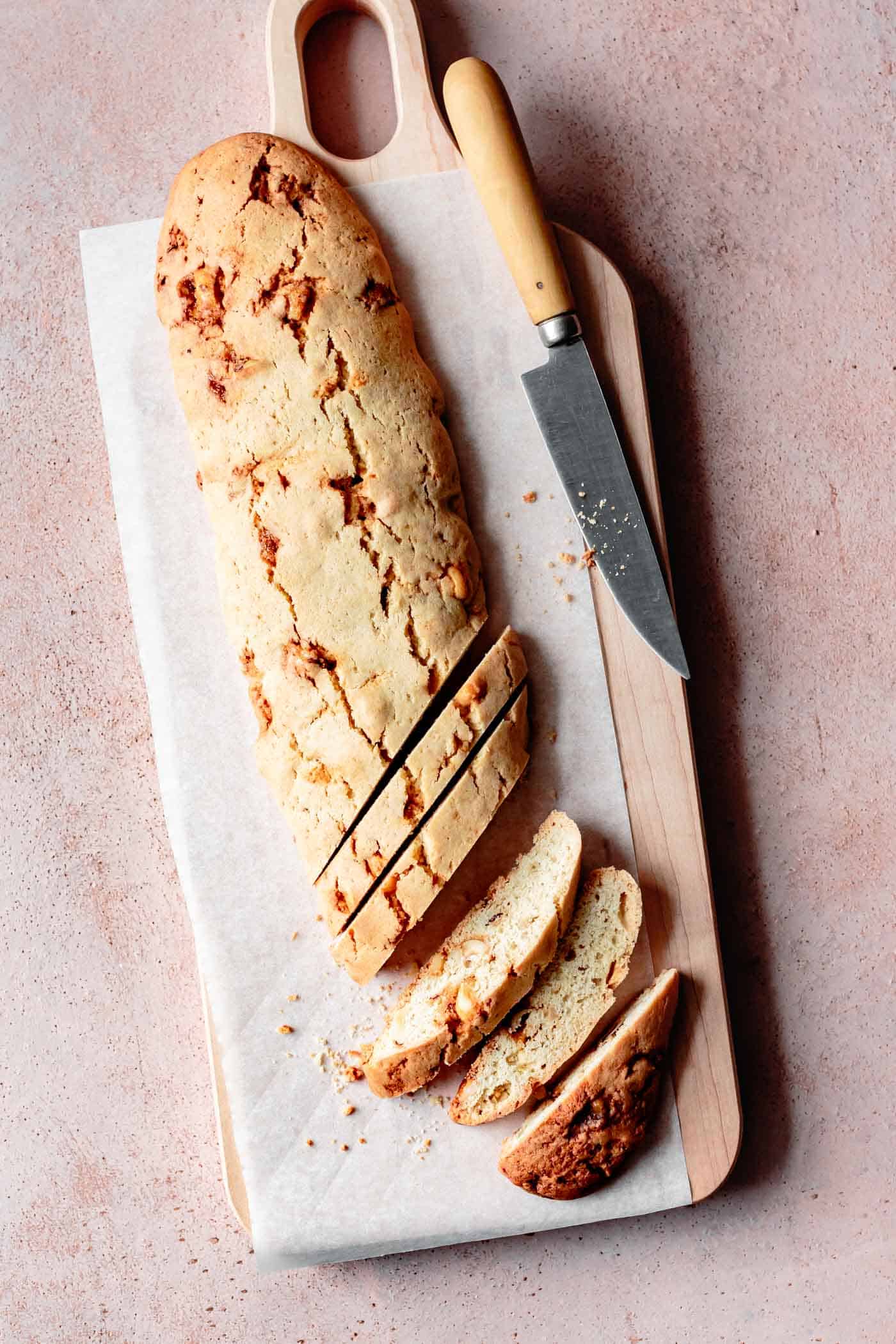 Gluten-free biscotti log being cut into slices