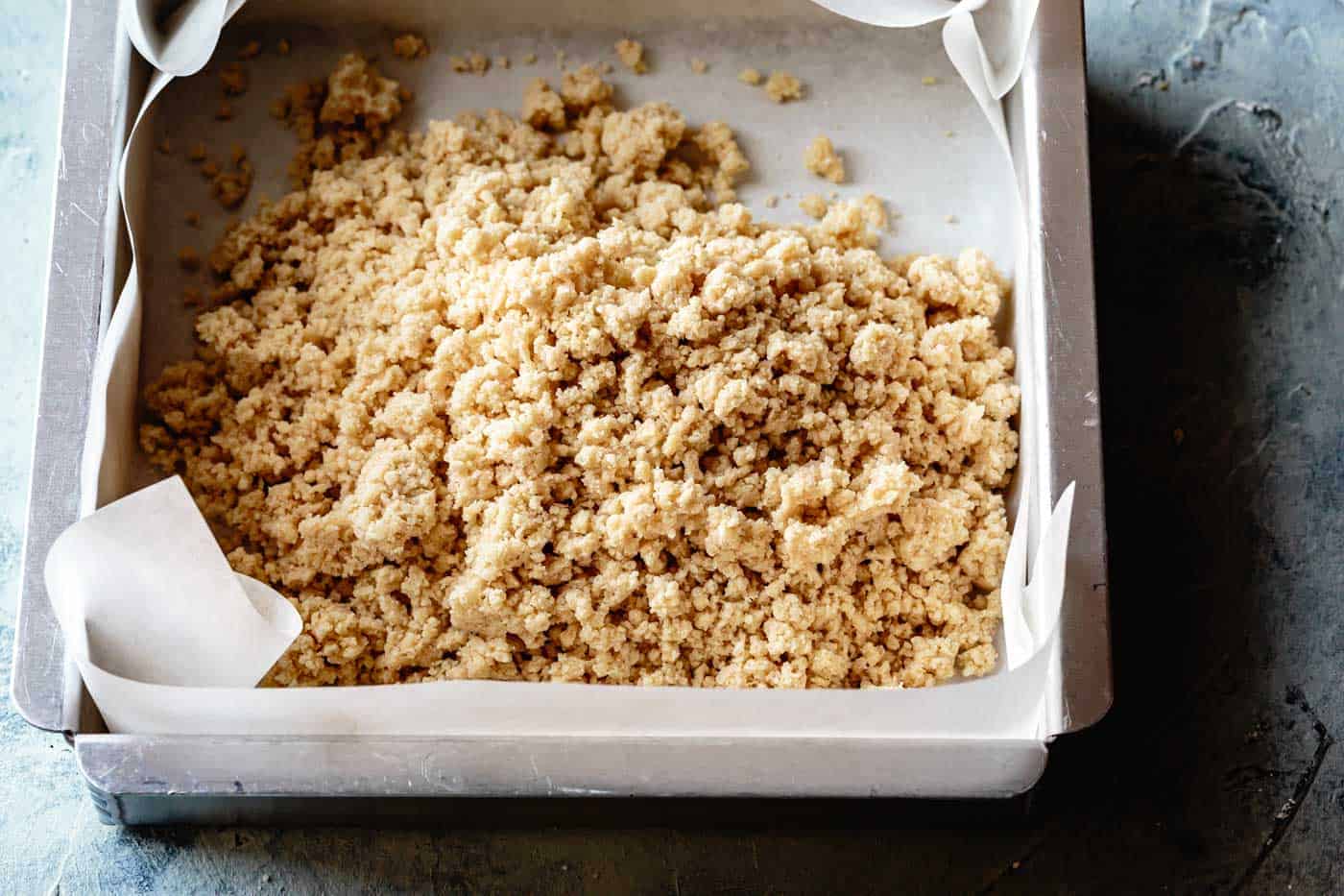 crumble dough for gluten-free shortbread crust in a pan