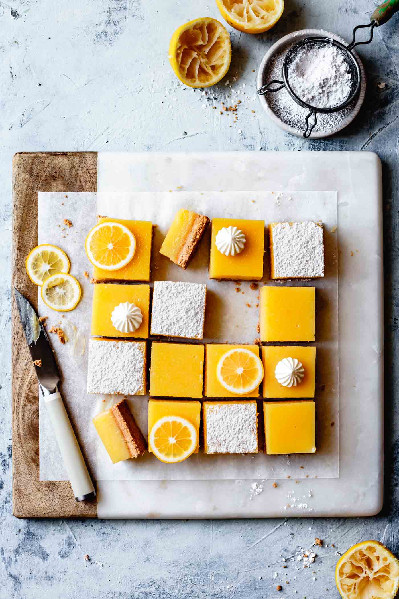 Gluten-free lemon tart or lemon bars recipe, decorated on a cutting board