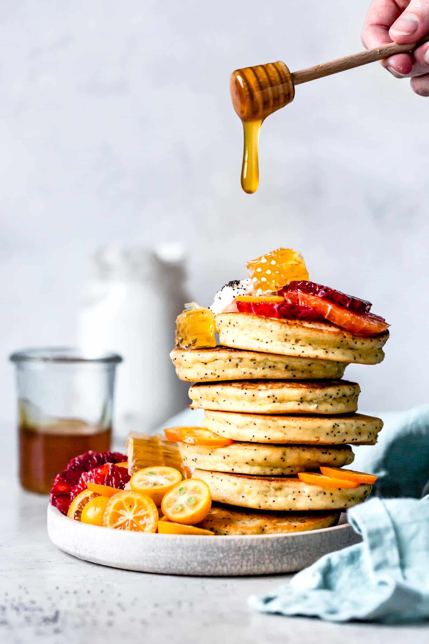 About to drizzle honey on a stack of grain-free pancakes