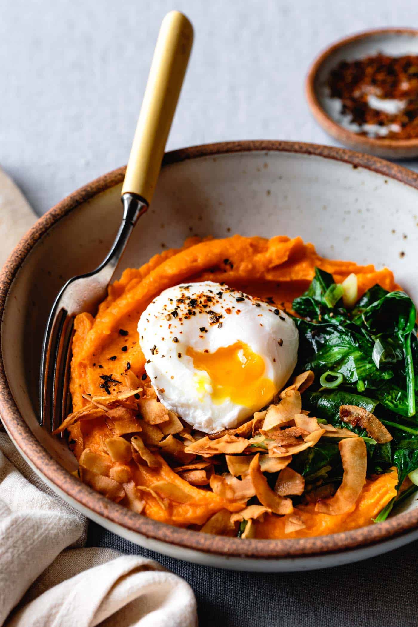 Serving healthy breakfast recipe with sweet potatoes - sweet potato bowl with eggs and greens