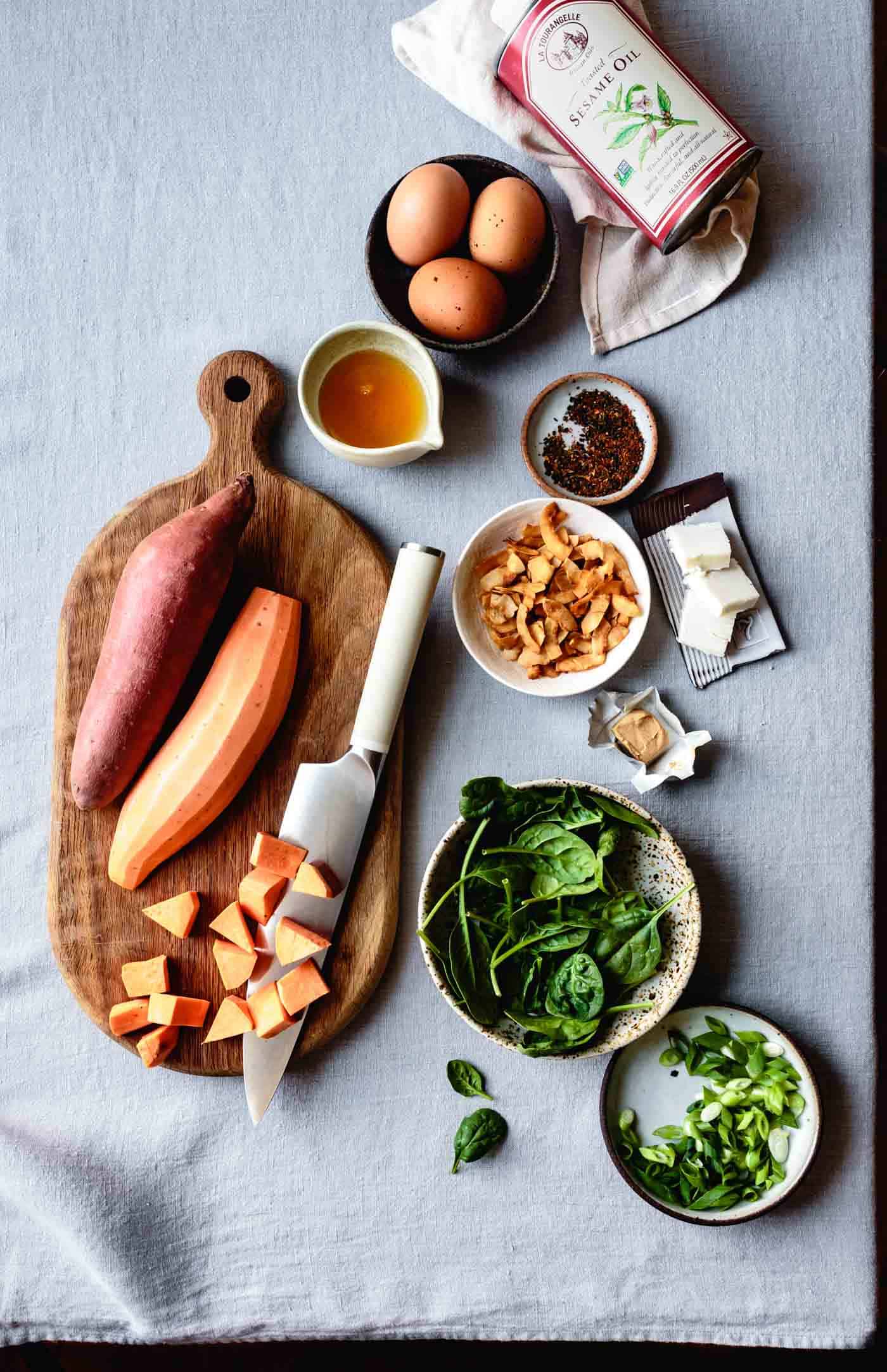 Ingredients for Sweet Potato Breakfast Bowl Recipe arranged on a linen surface