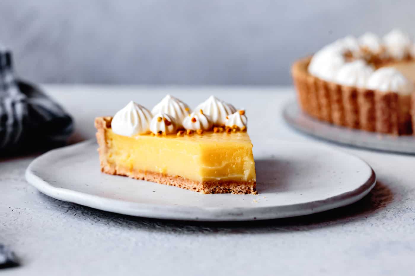 slice of lemon tart with a bite taken out