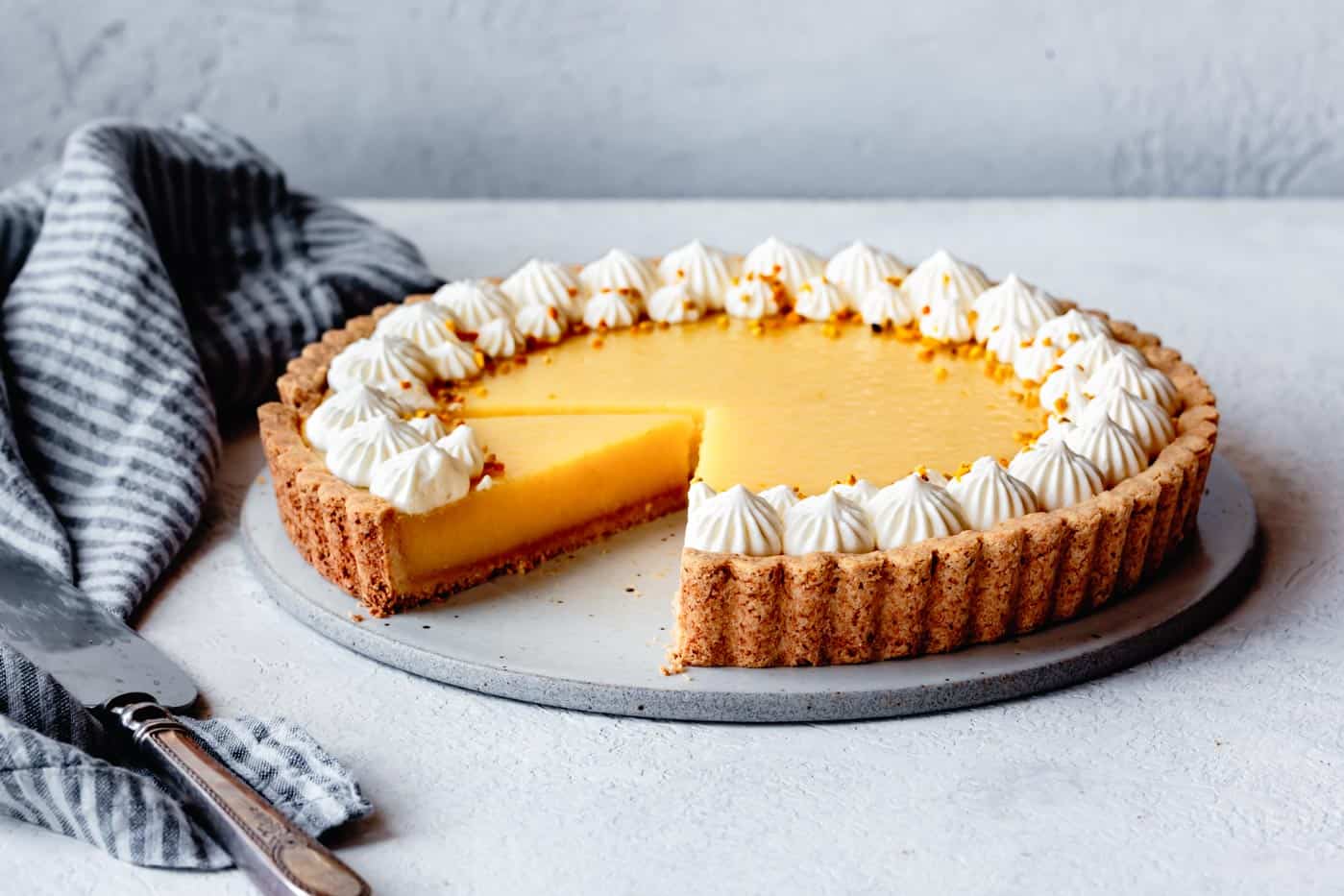 gluten-free lemon tart with a slice cut out