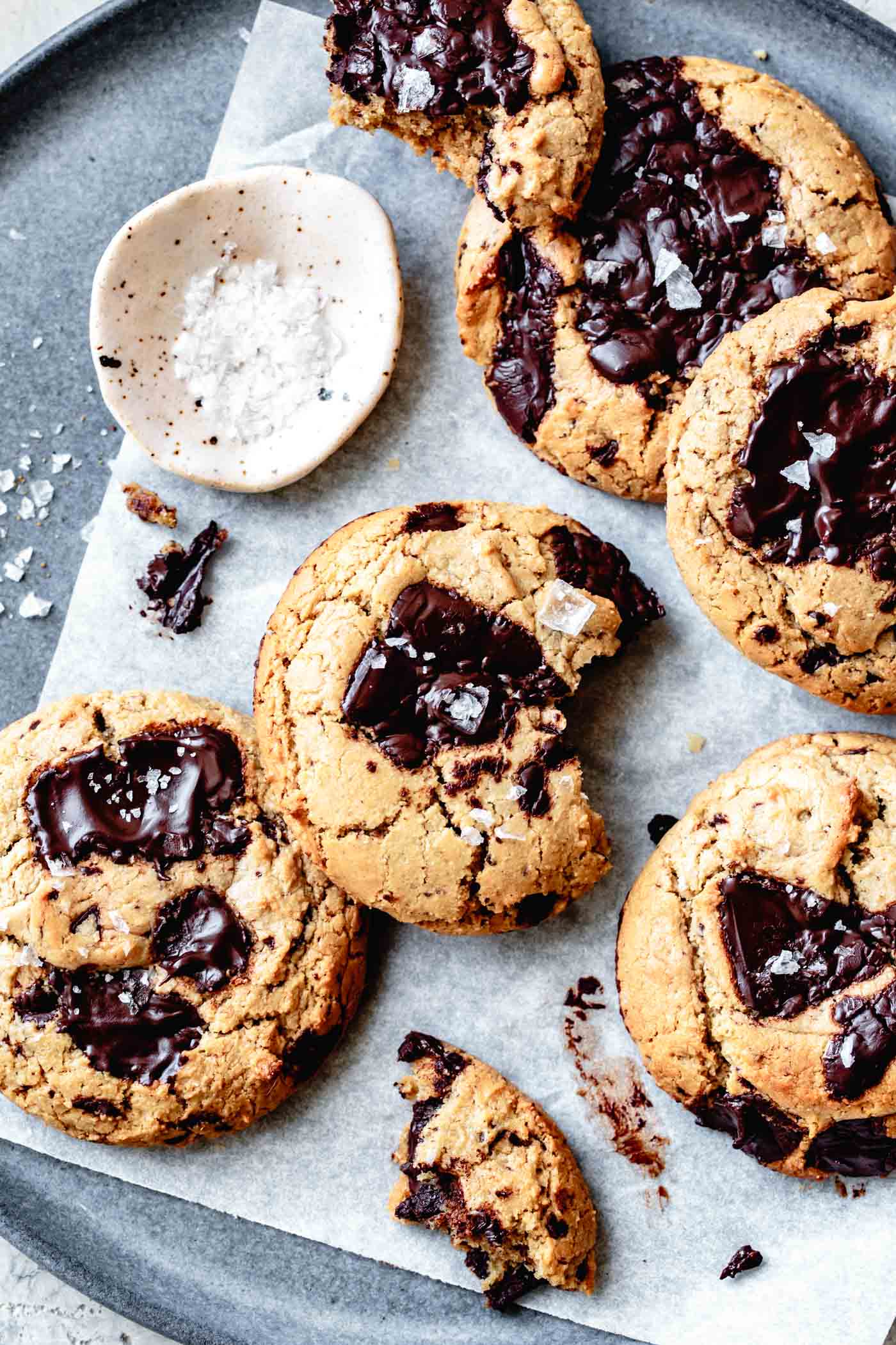 a plate full of glossy paleo vegan chocolate chip cookies