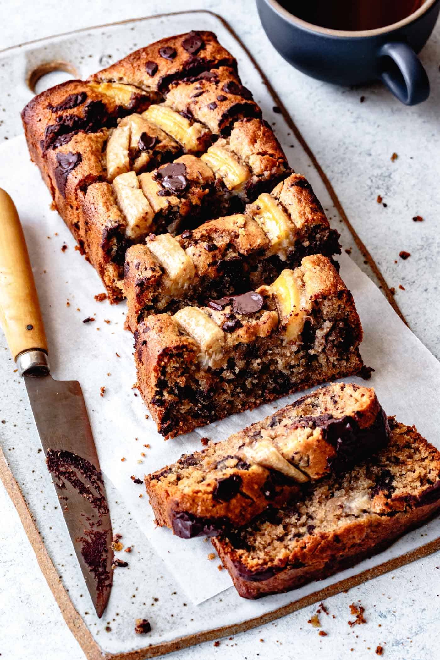 Side angle of sliced loaf of paleo chocolate chip banana bread