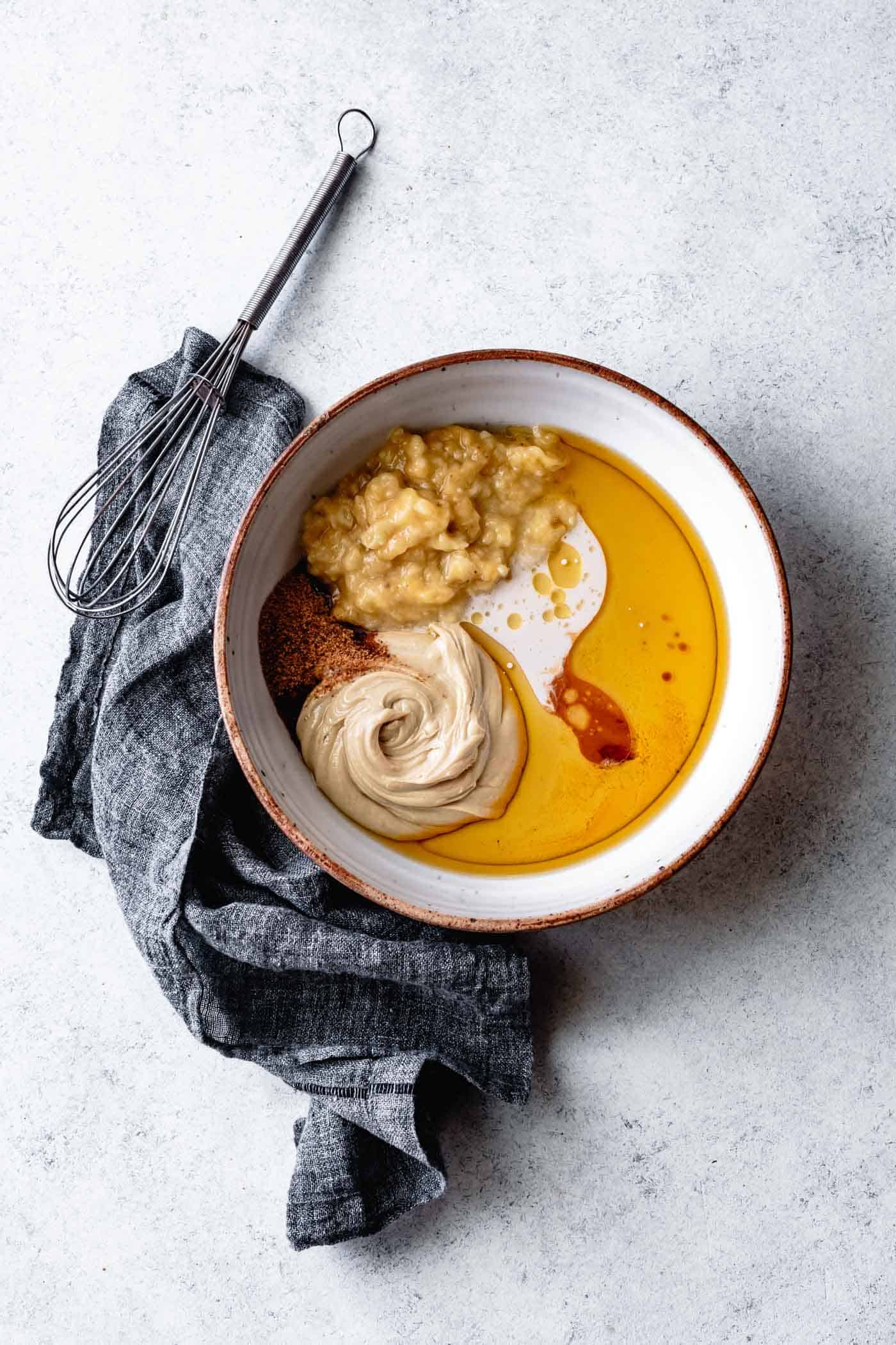 Wet ingredients for vegan paleo banana bread recipe in a bowl