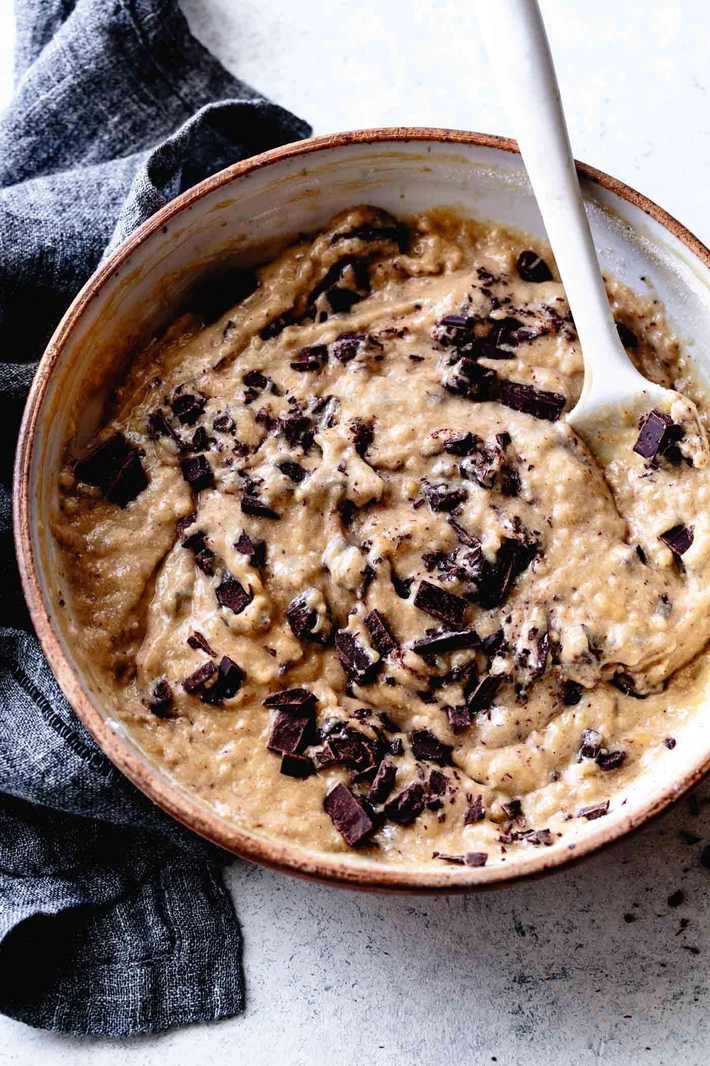 Stirring chocolate into the batter for grain-free banana bread