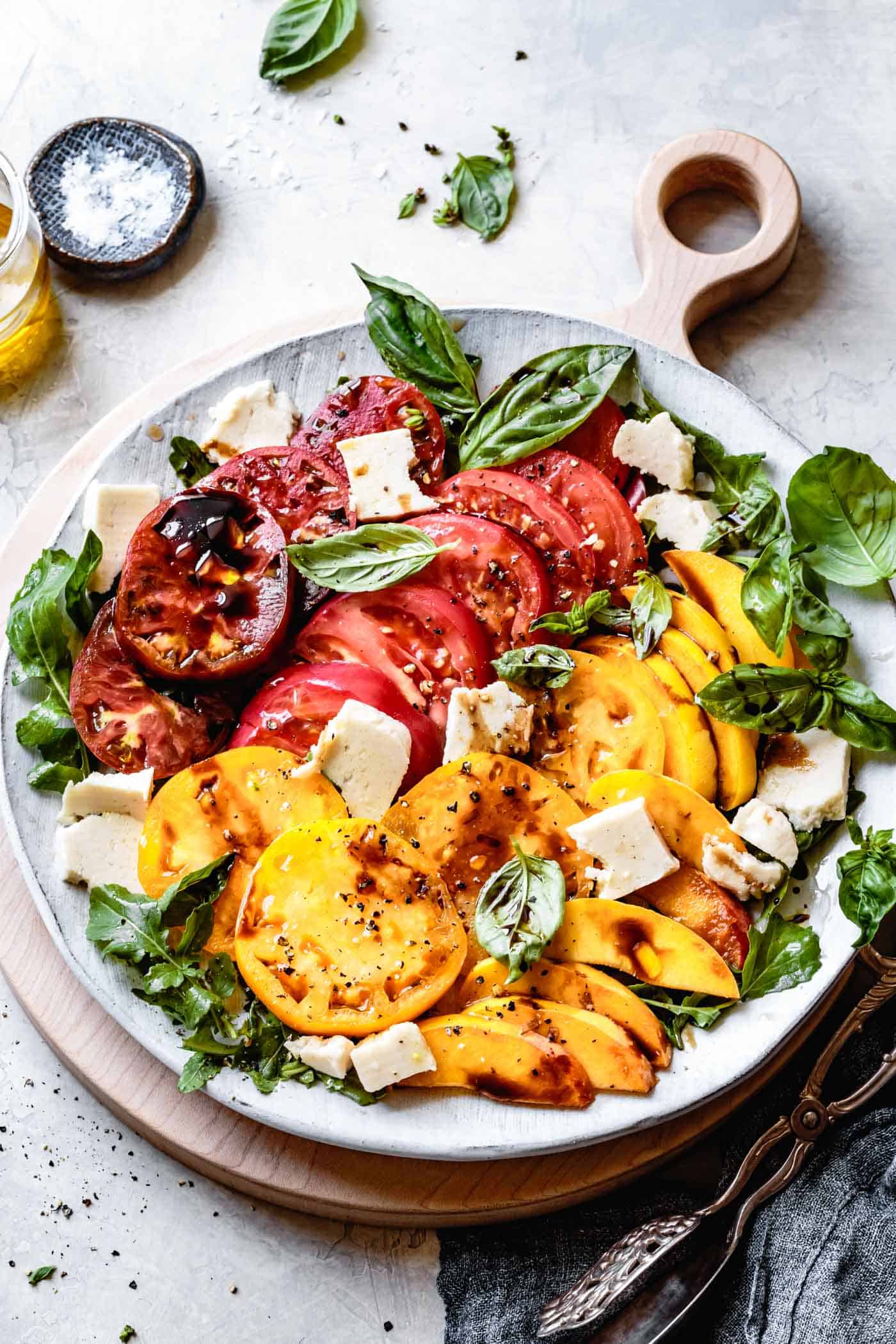 Vegan arugula peach caprese salad recipe on a platter