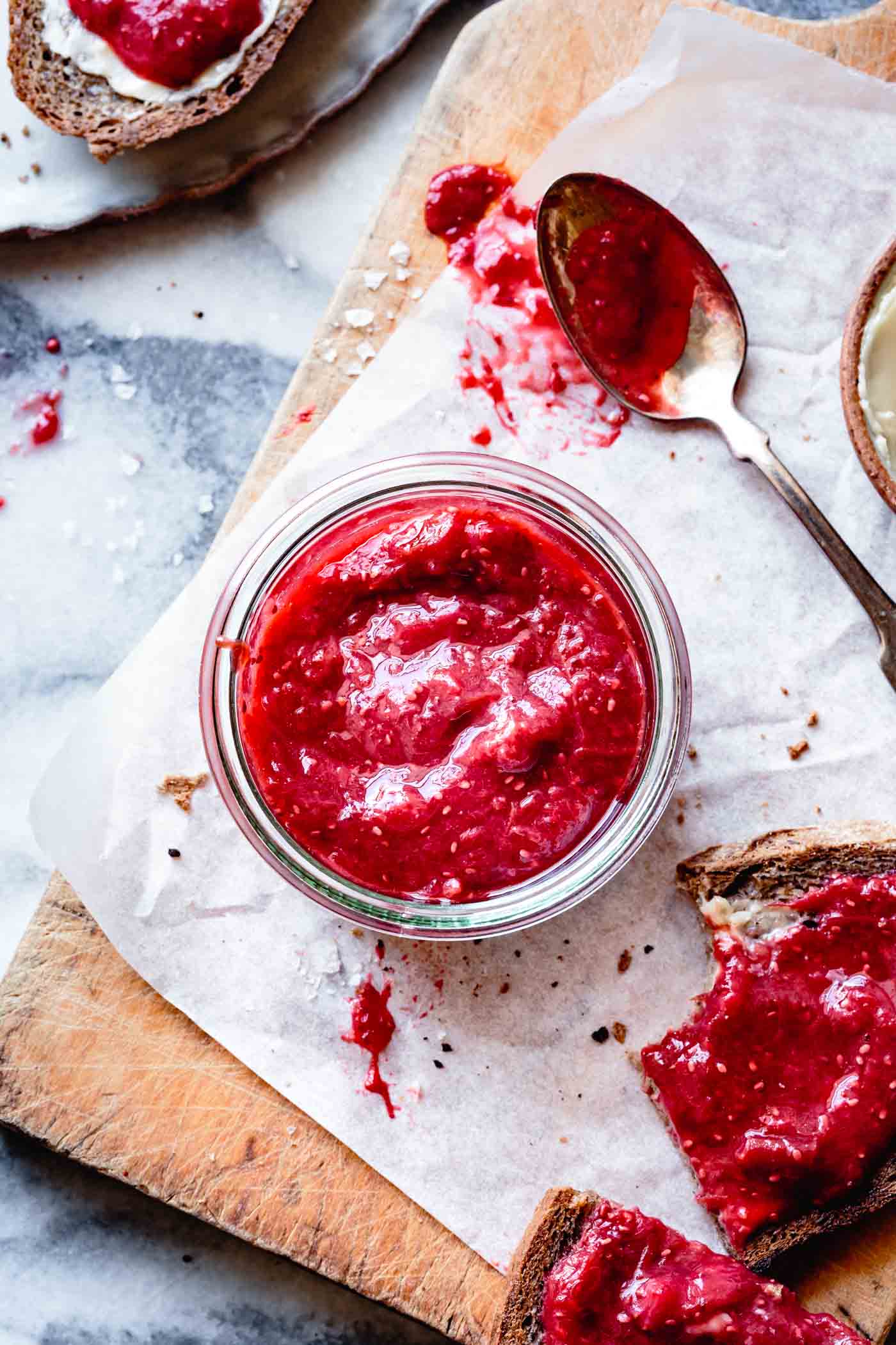 Low-sugar strawberry rhubarb compote in a jar and on toast