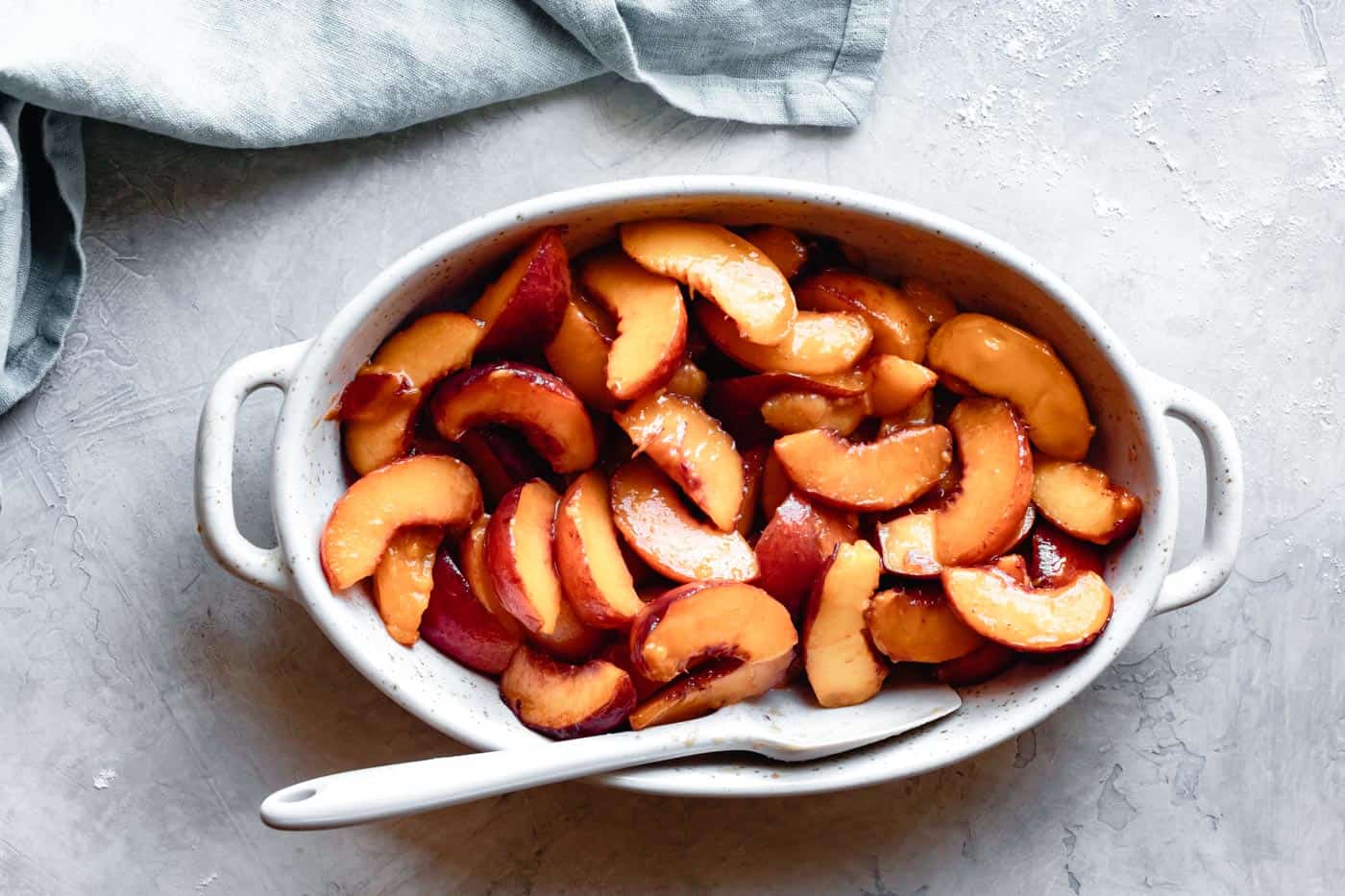 peaches in a baking pan for paleo vegan peach cobbler