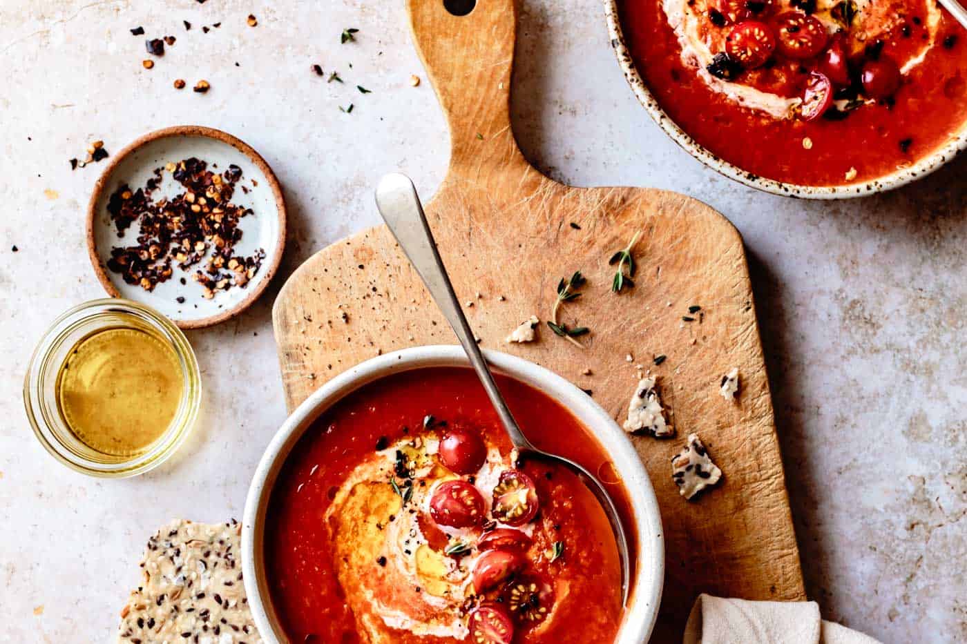 wide image of bowls of vegan tomato soup made with fresh tomatoes