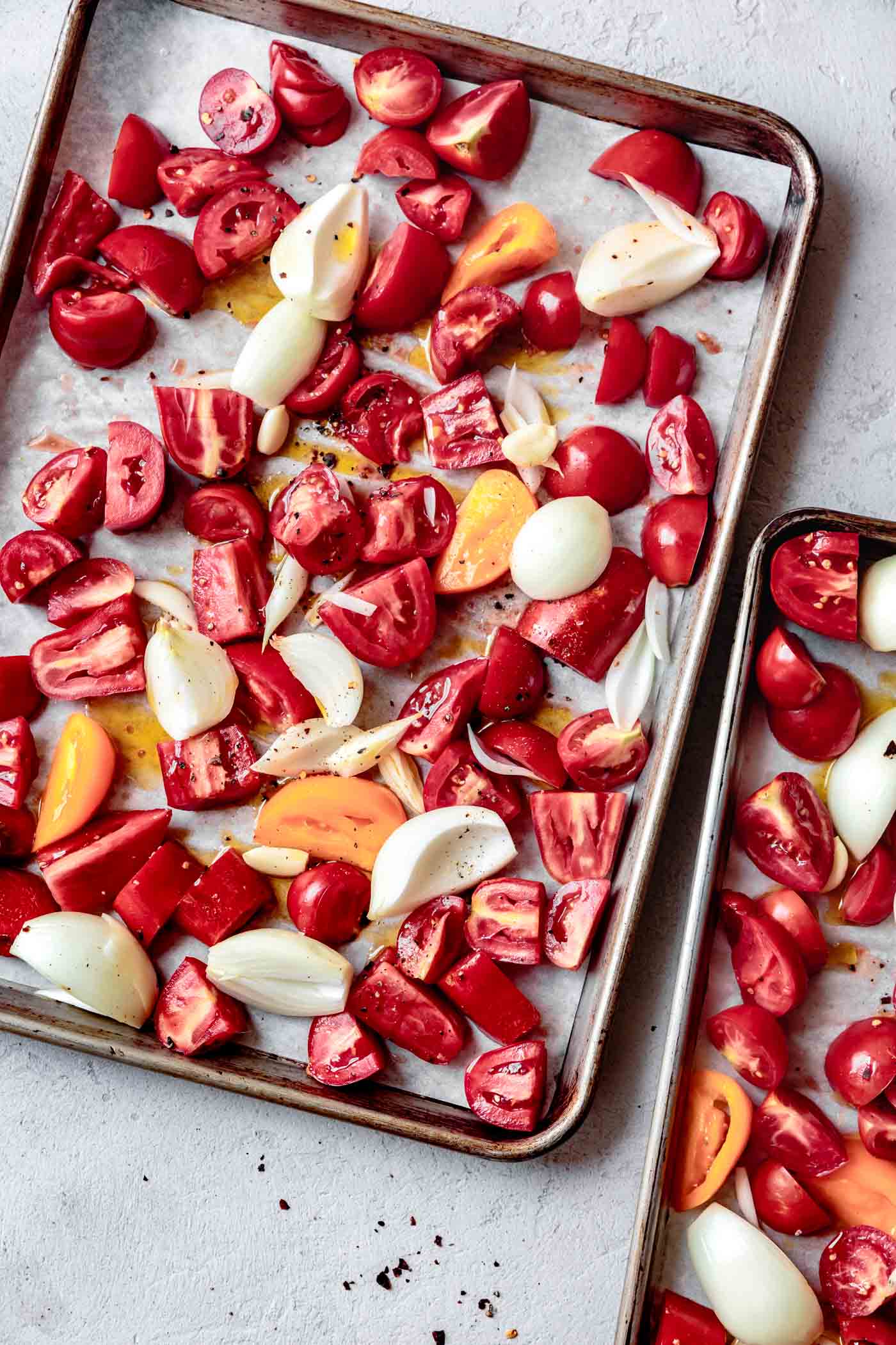 tomatoes, onion, and garlic ready to be roasted for vegan tomato soup recipe