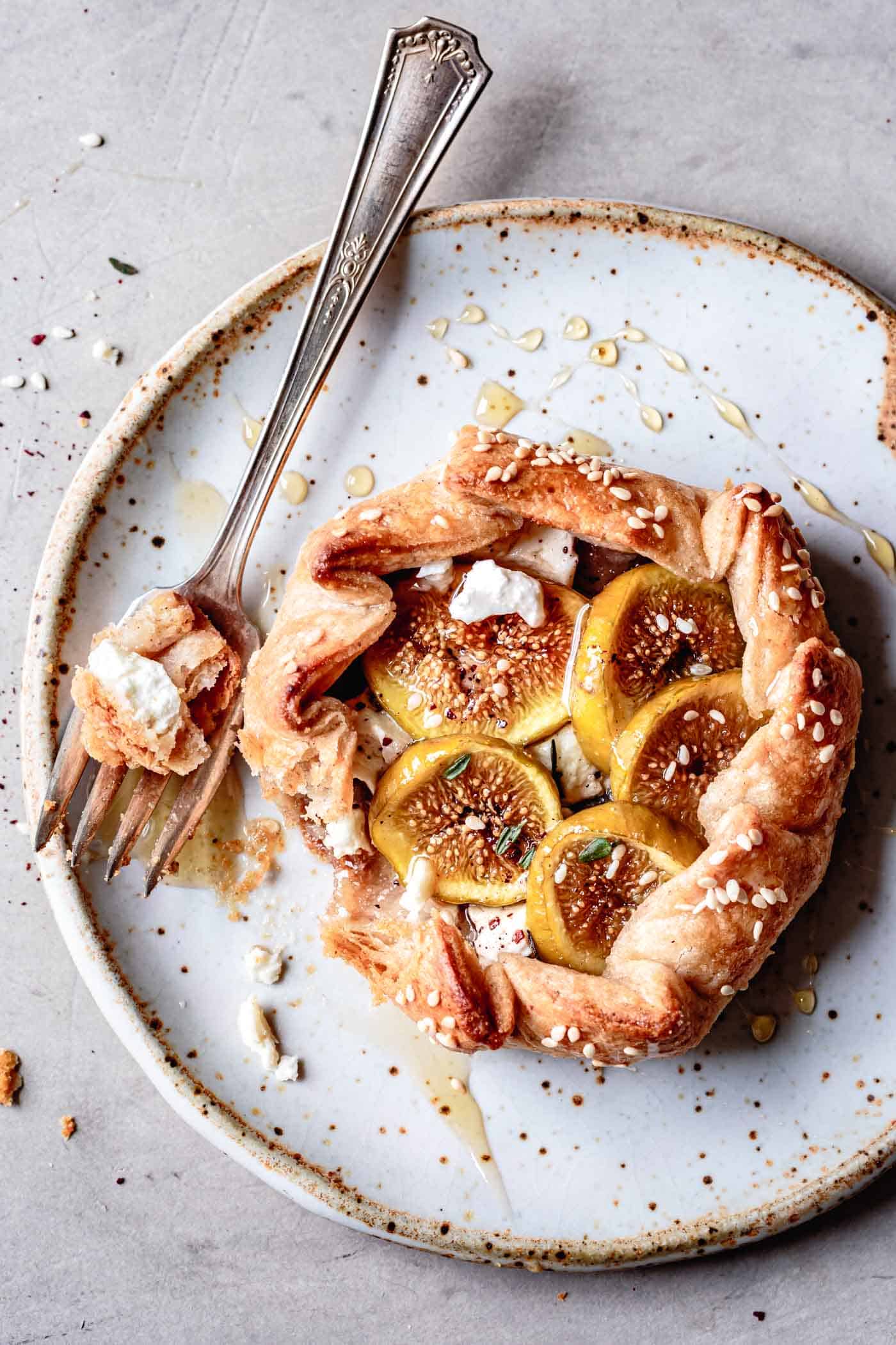 fig galette on a plate, drizzled with honey