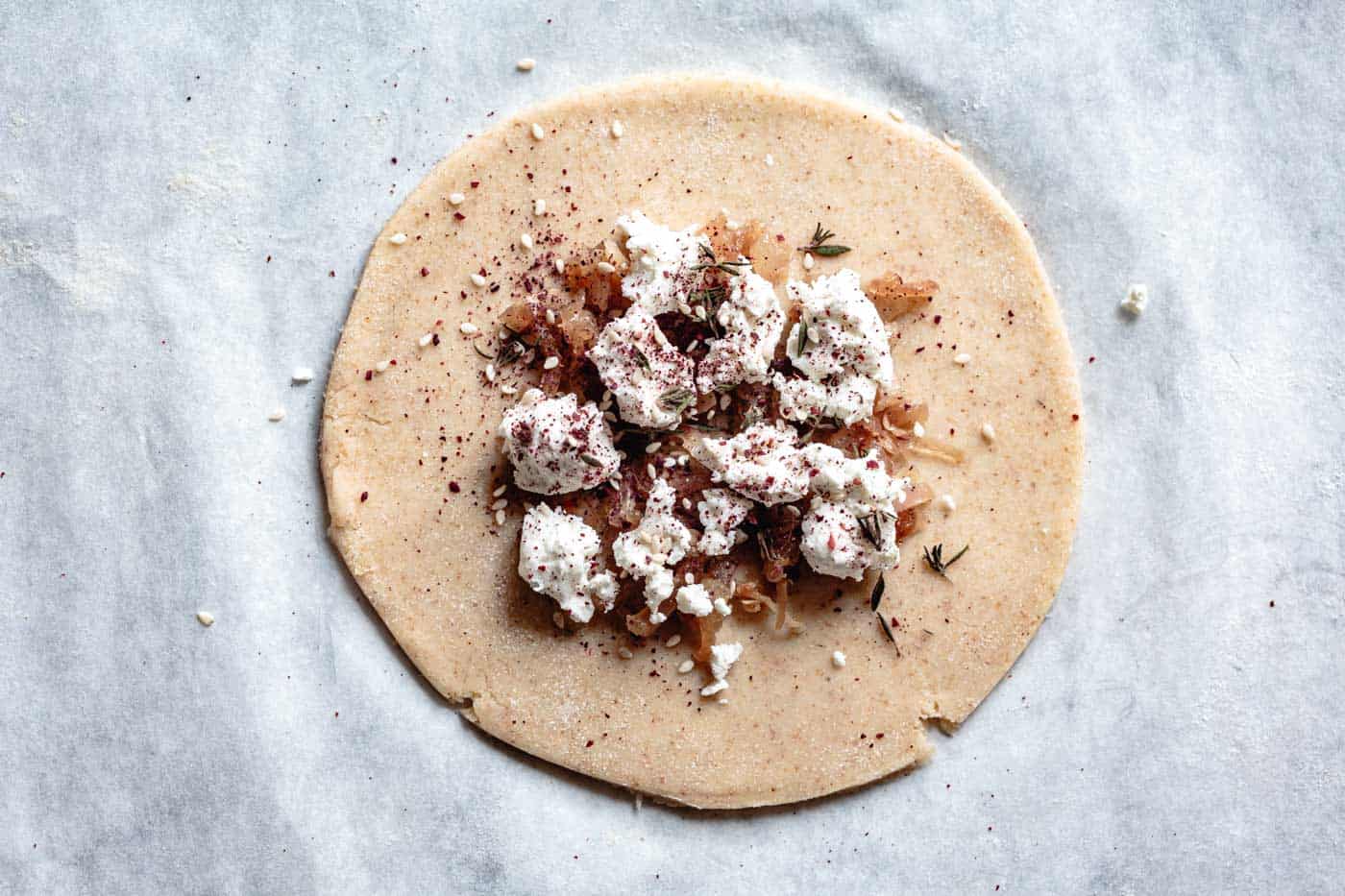 sprinkling za'atar over goat cheese