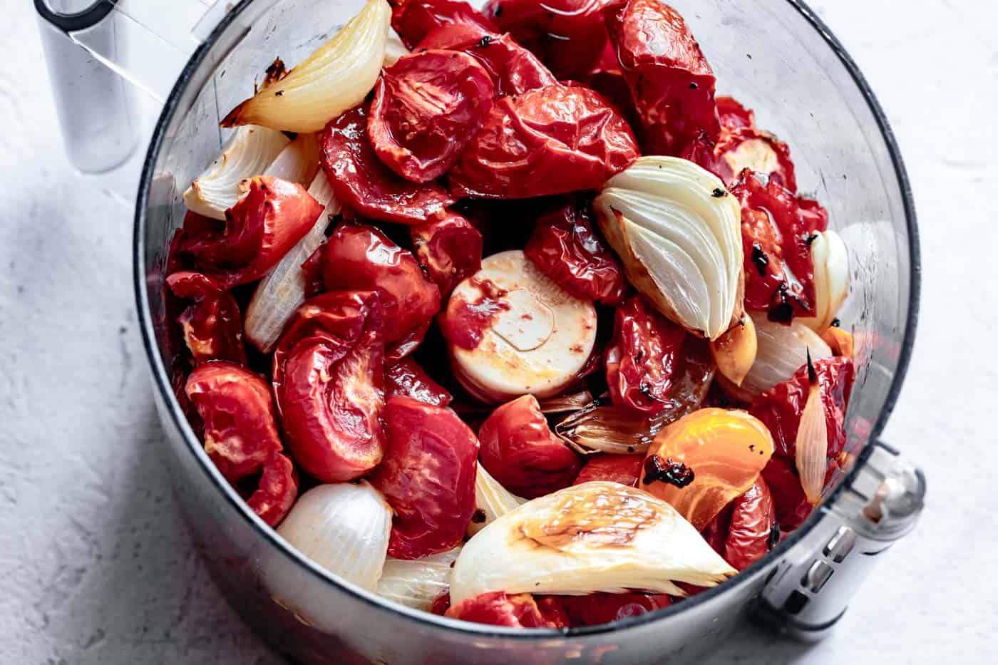 pureeing roasted vegetables for vegan tomato soup with fresh tomatoes