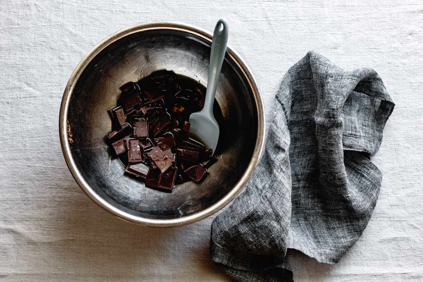 chocolate and oil in bowl for flourless chocolate almond cake recipe