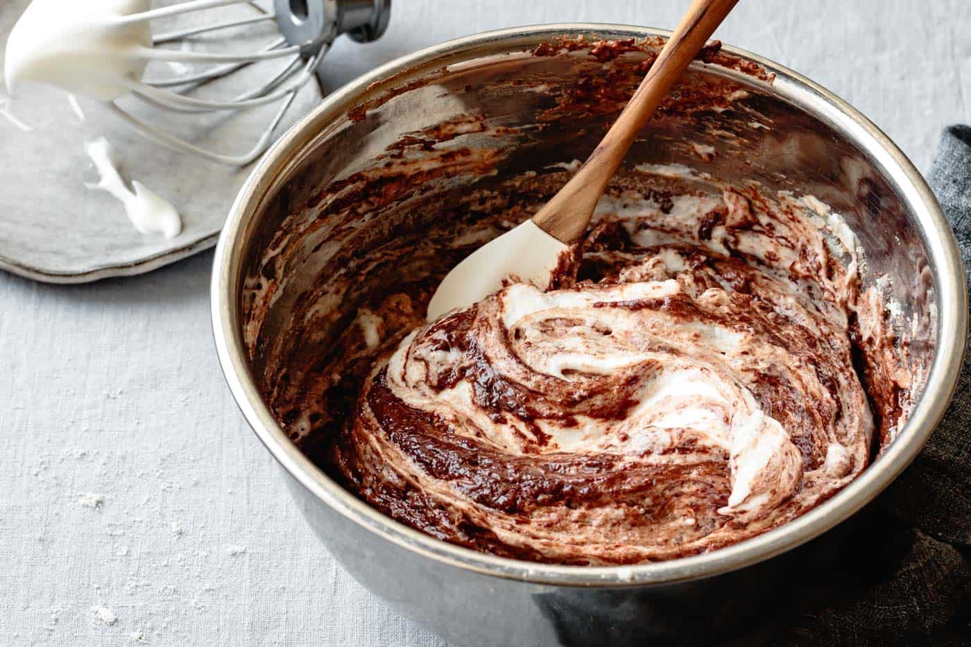 folding egg whites into chocolate olive oil cake batter