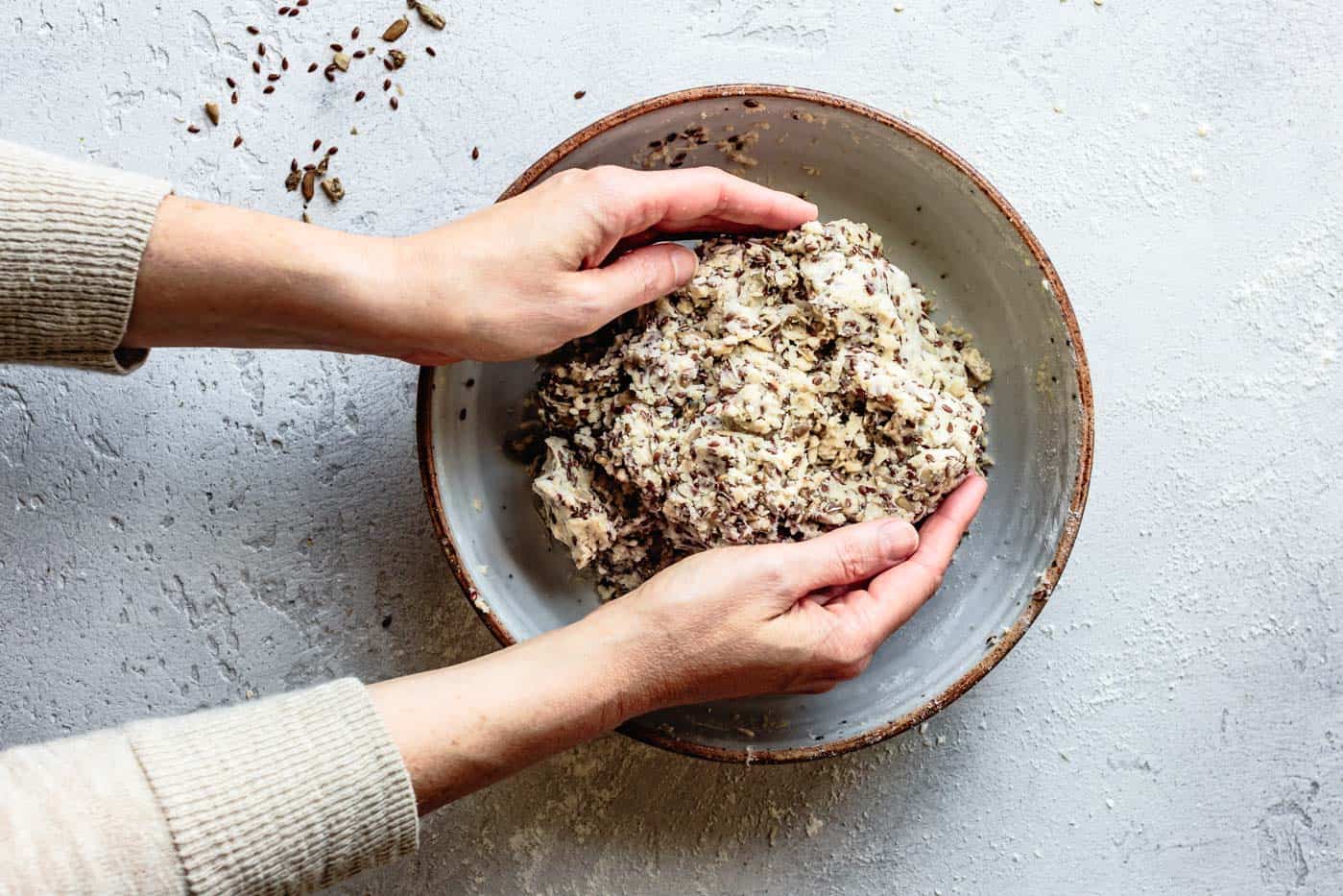 kneading the gluten-free cracker dough in a bowl