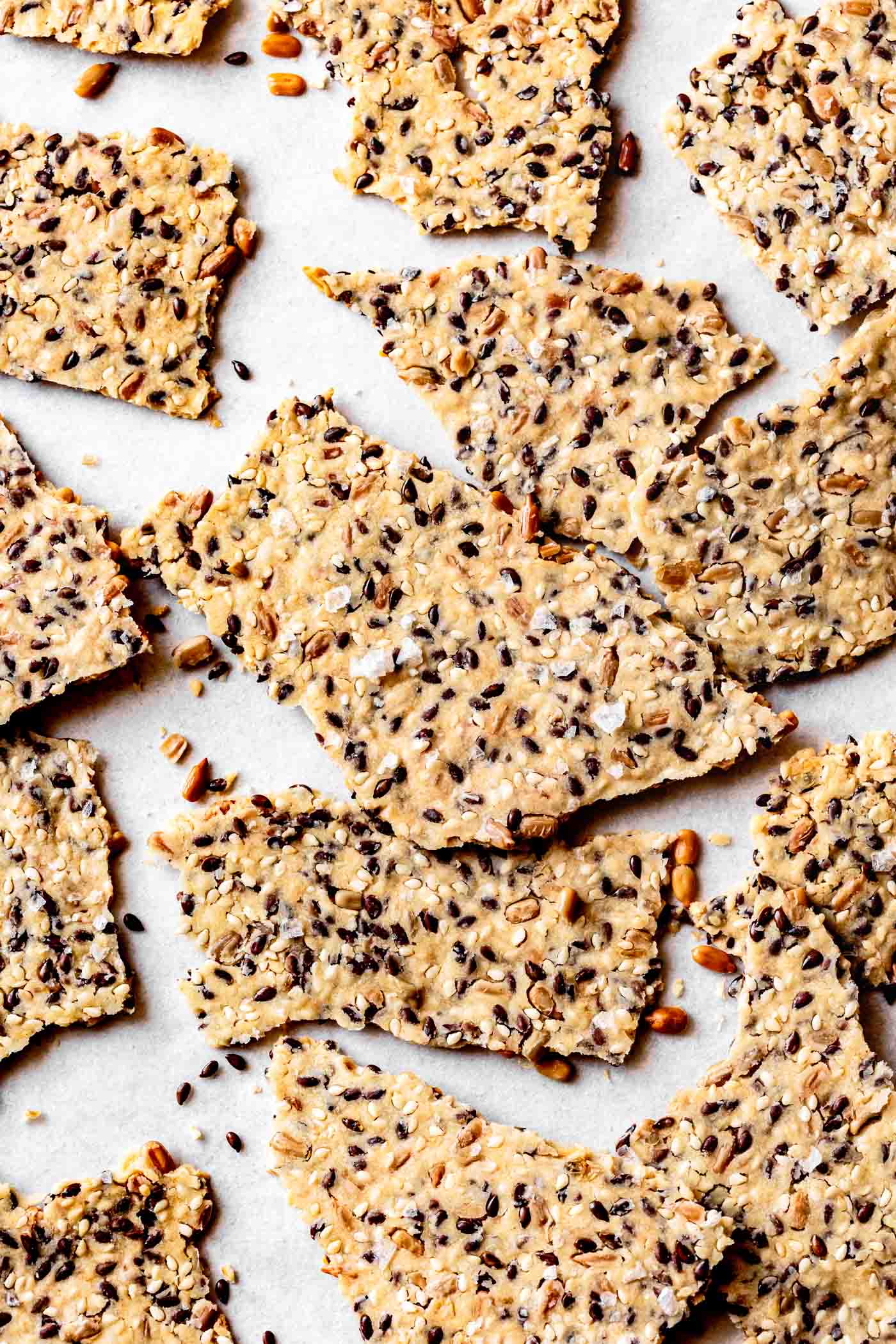 seedy paleo crackers on parchment paper