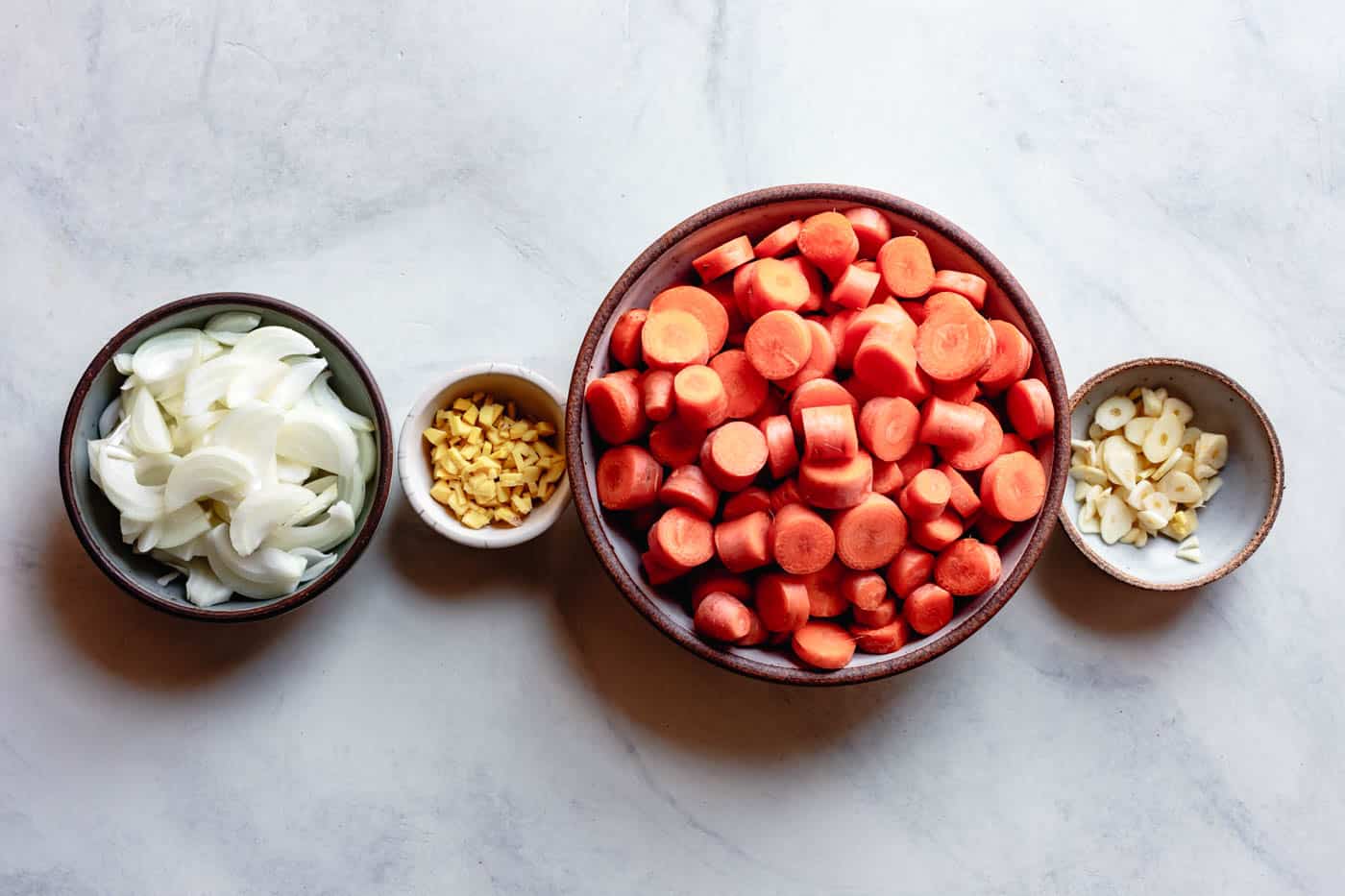 prepped carrots, onions, garlic, and ginger for curried carrot soup recipe