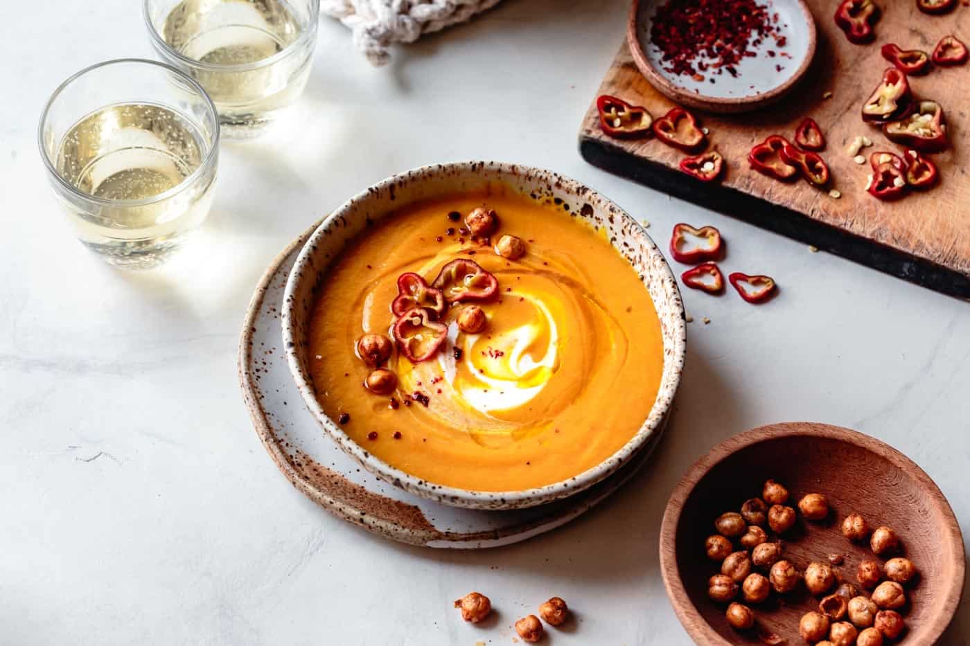 wide angle of bowl of carrot ginger coconut curry soup