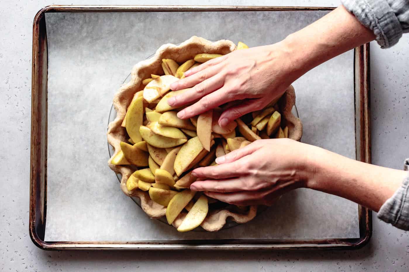 packing apples into crust for paleo apple pie recipe