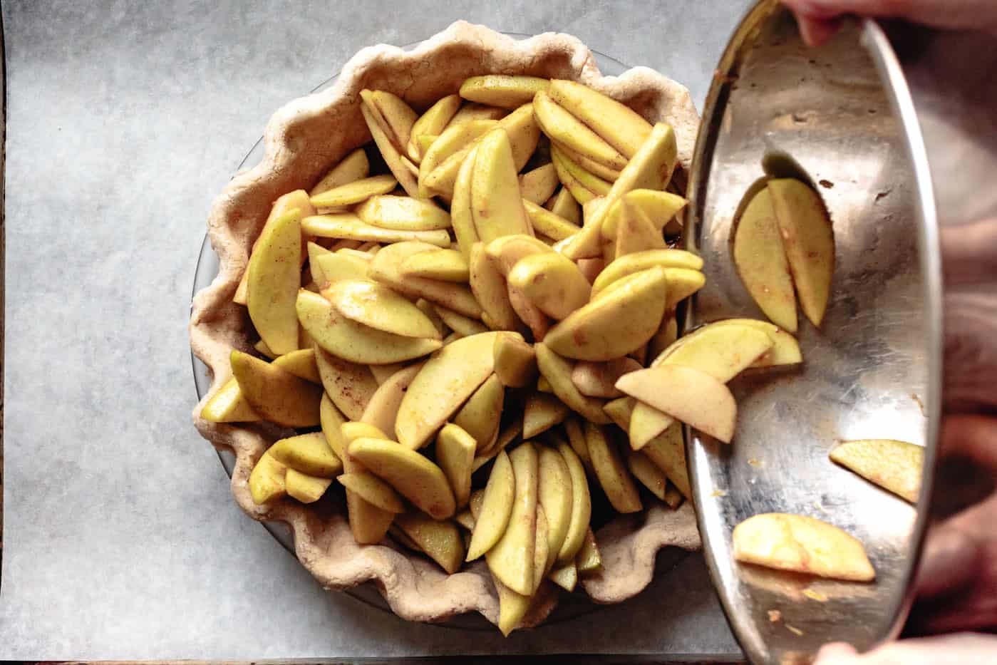 pouring maple apples into crust