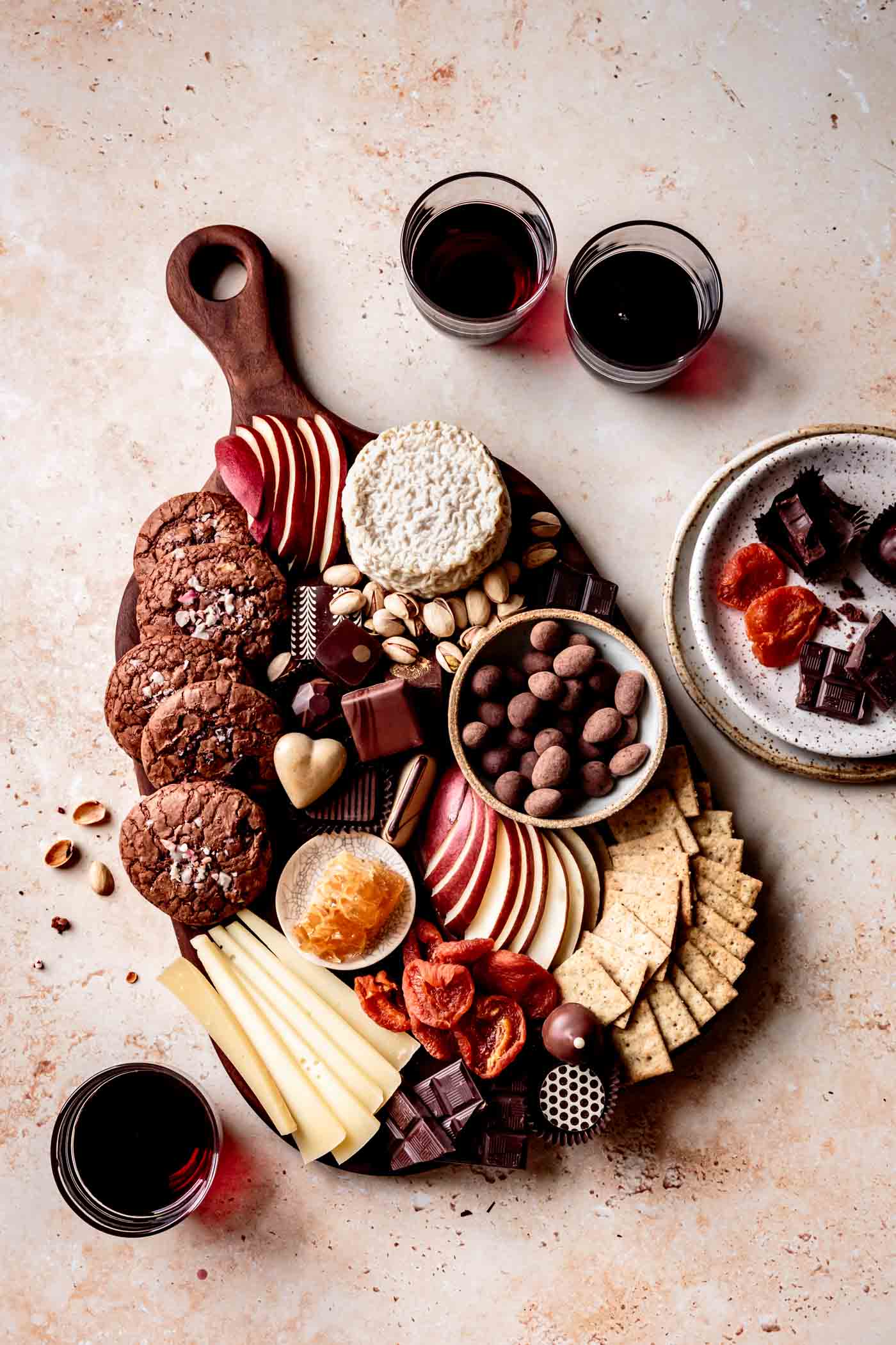 chocolate board overhead with glasses of red wine