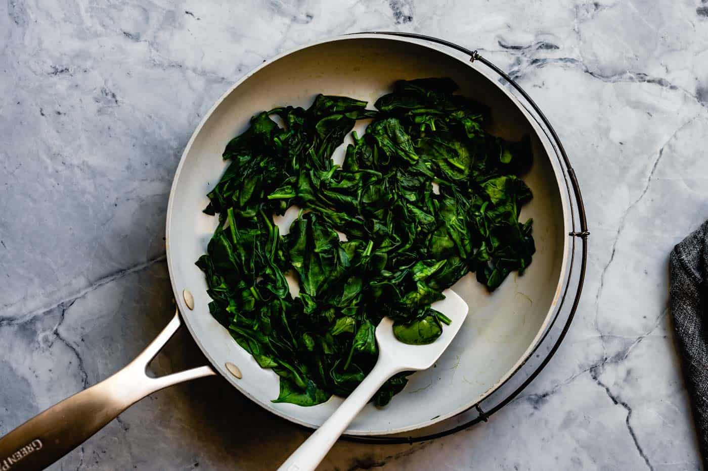 wilting spinach in a skillet