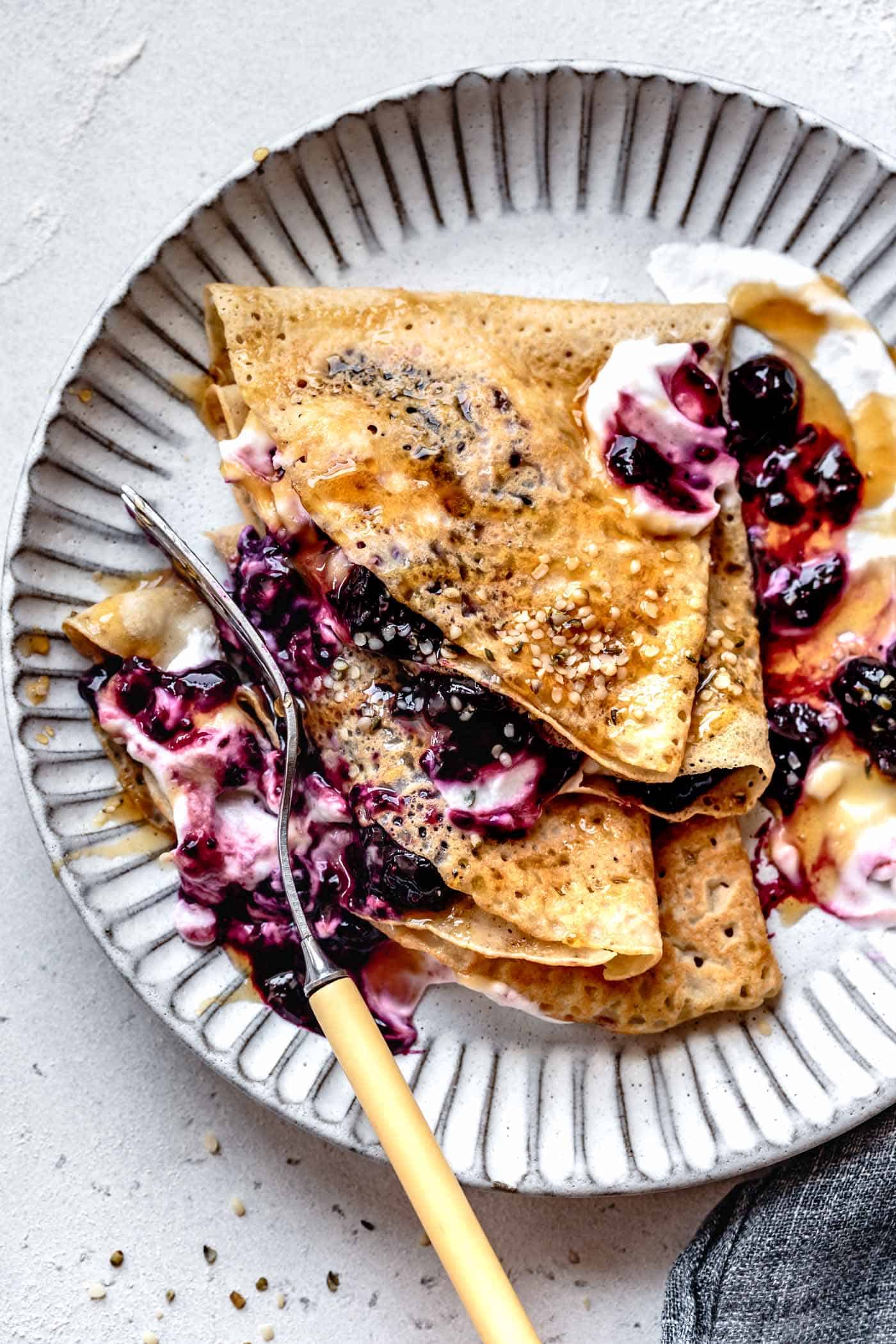 eating almond flour crepes with a fork