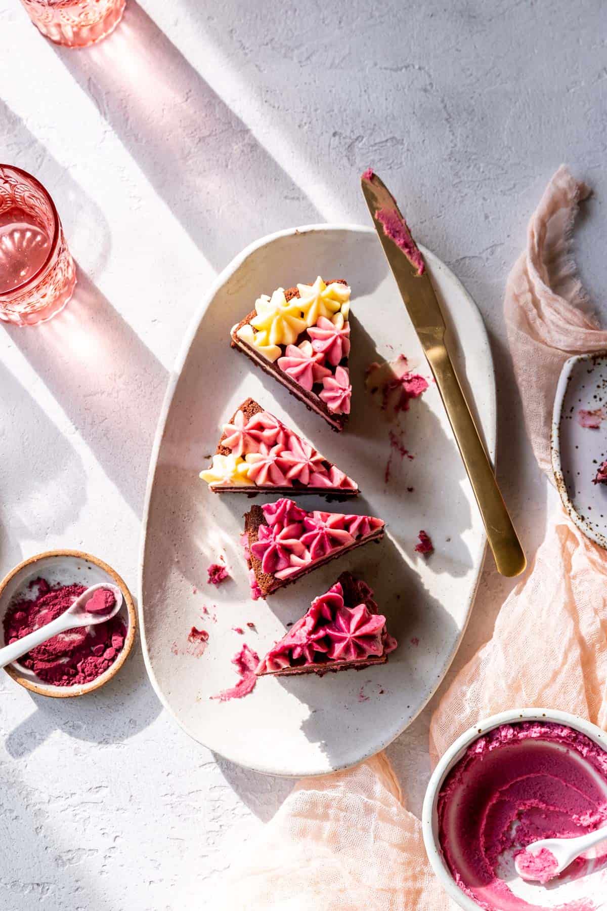 slices of red velvet cake are on a white oval platter