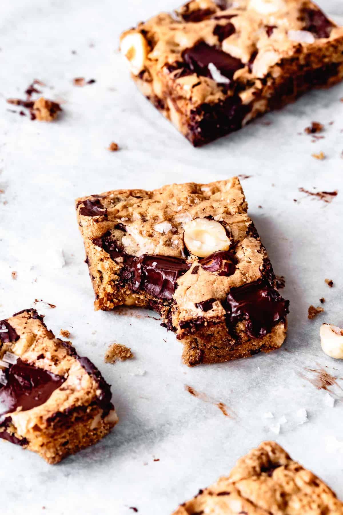 gluten-free blondies with a bite taken out on parchment paper