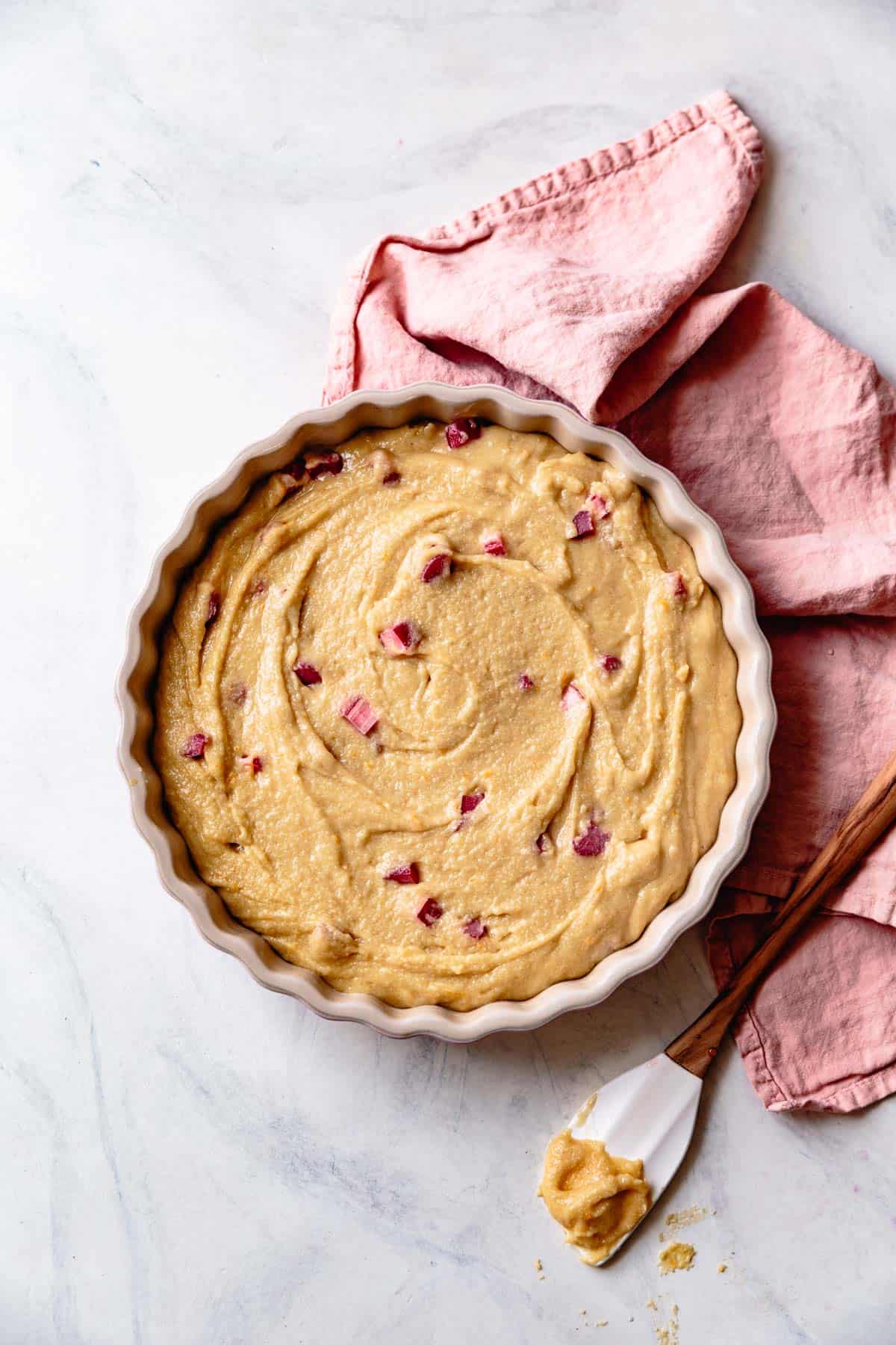 rhubarb cake batter in a baking pan